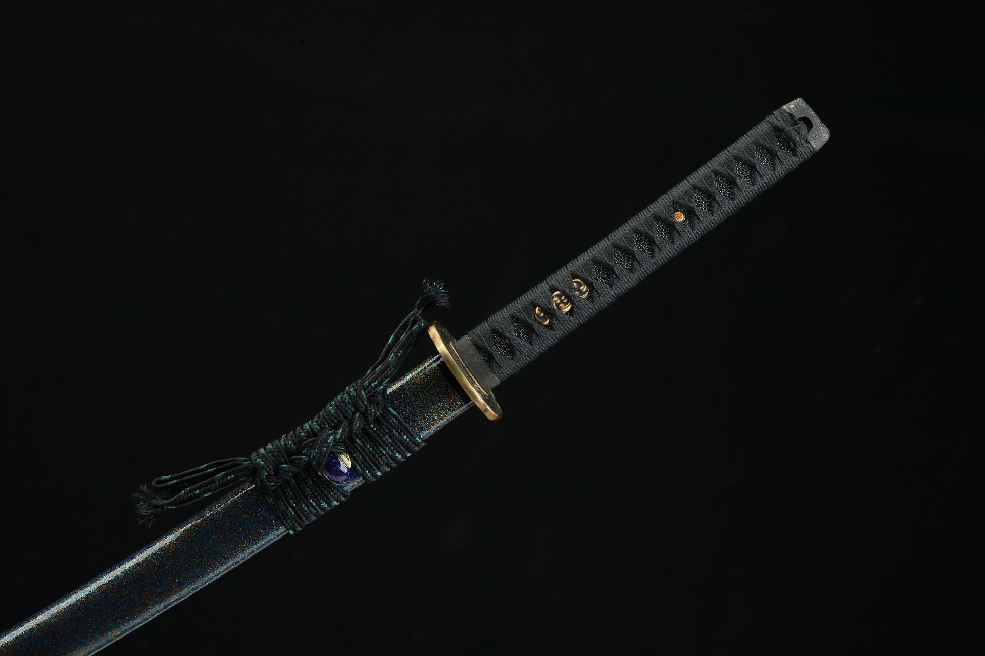 Side view of the Magatama katana's hilt and scabbard, showcasing intricate wrapping and metallic accents.