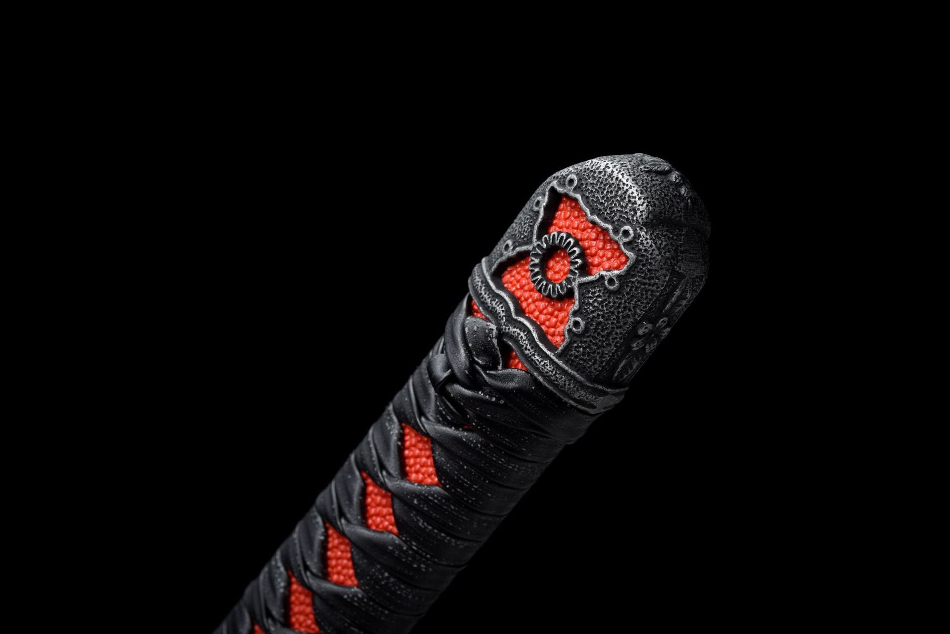 Close-up of the Kashira of the Mortal Blade from Sekiro with intricate engraved decorations.