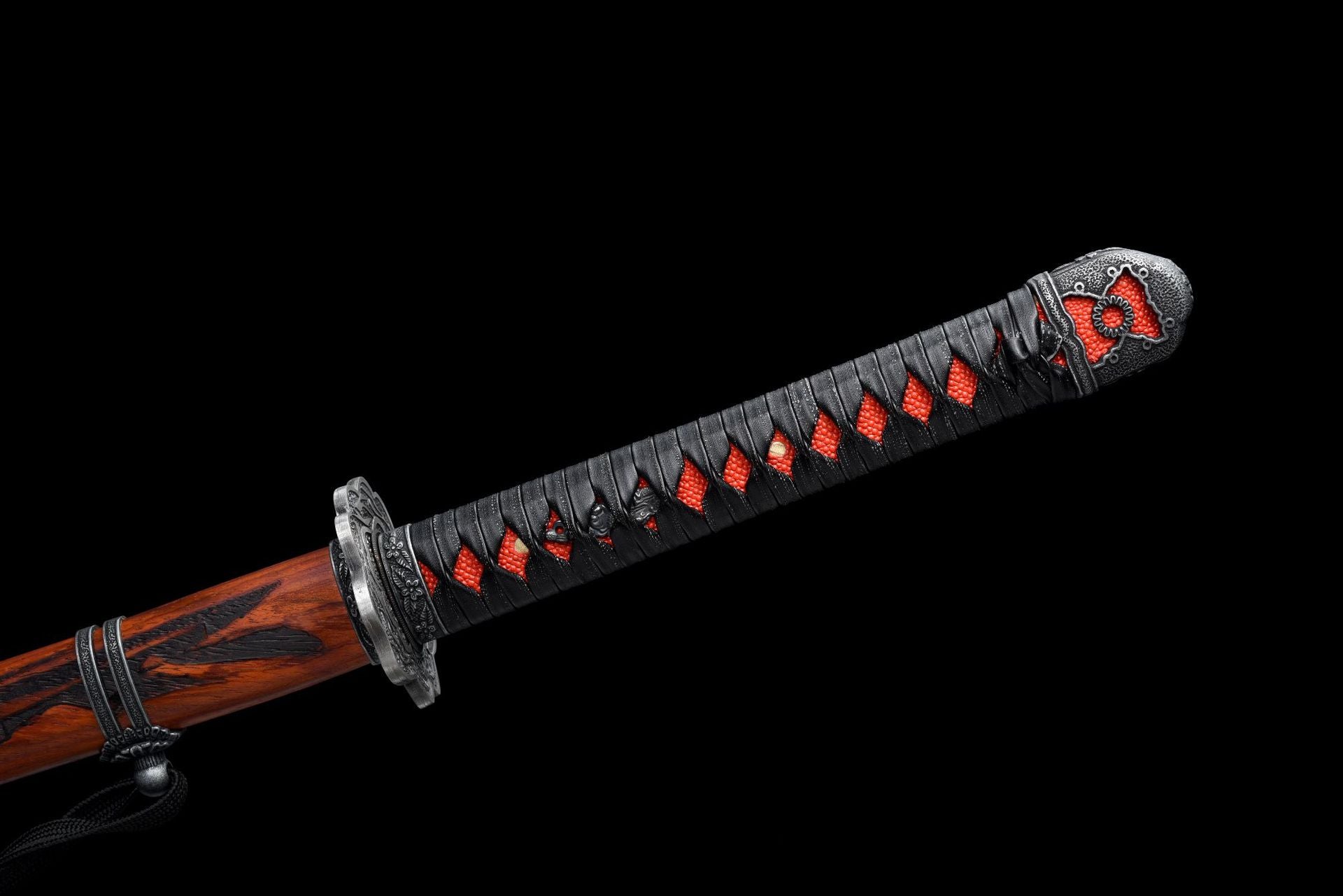The red Tsuka of the Mortal Blade wrapped in black Tsuka-maki.