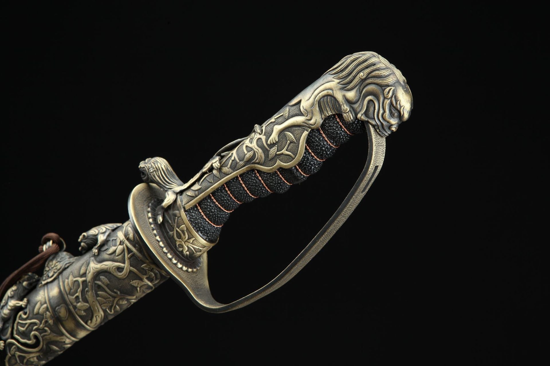 Ornate tsuka of Nine Lions gunto with intricate carvings and lion-shaped pommel.