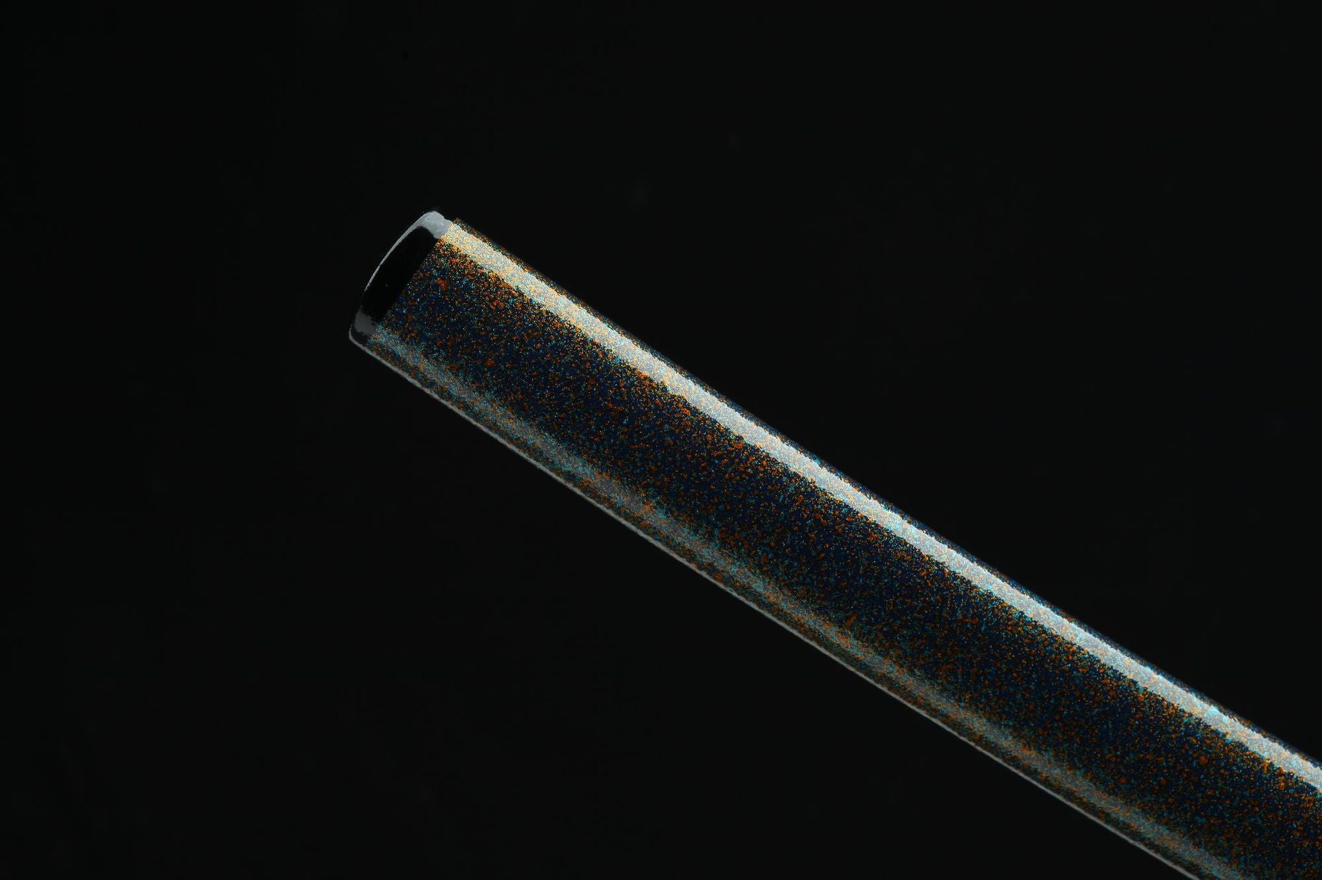 Close-up of a premium urushi lacquered katana scabbard with a speckled metallic finish.