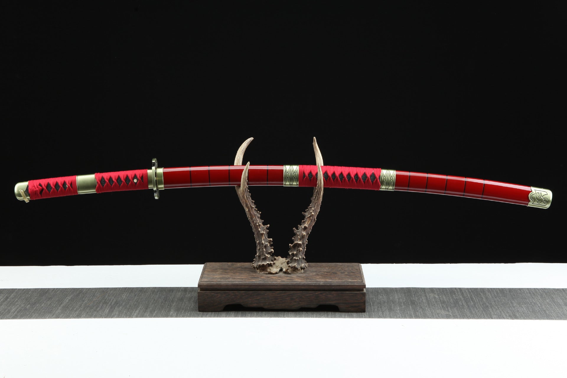Roronoa Zoro's Sandai Kitetsu sword displayed on a sword rack.