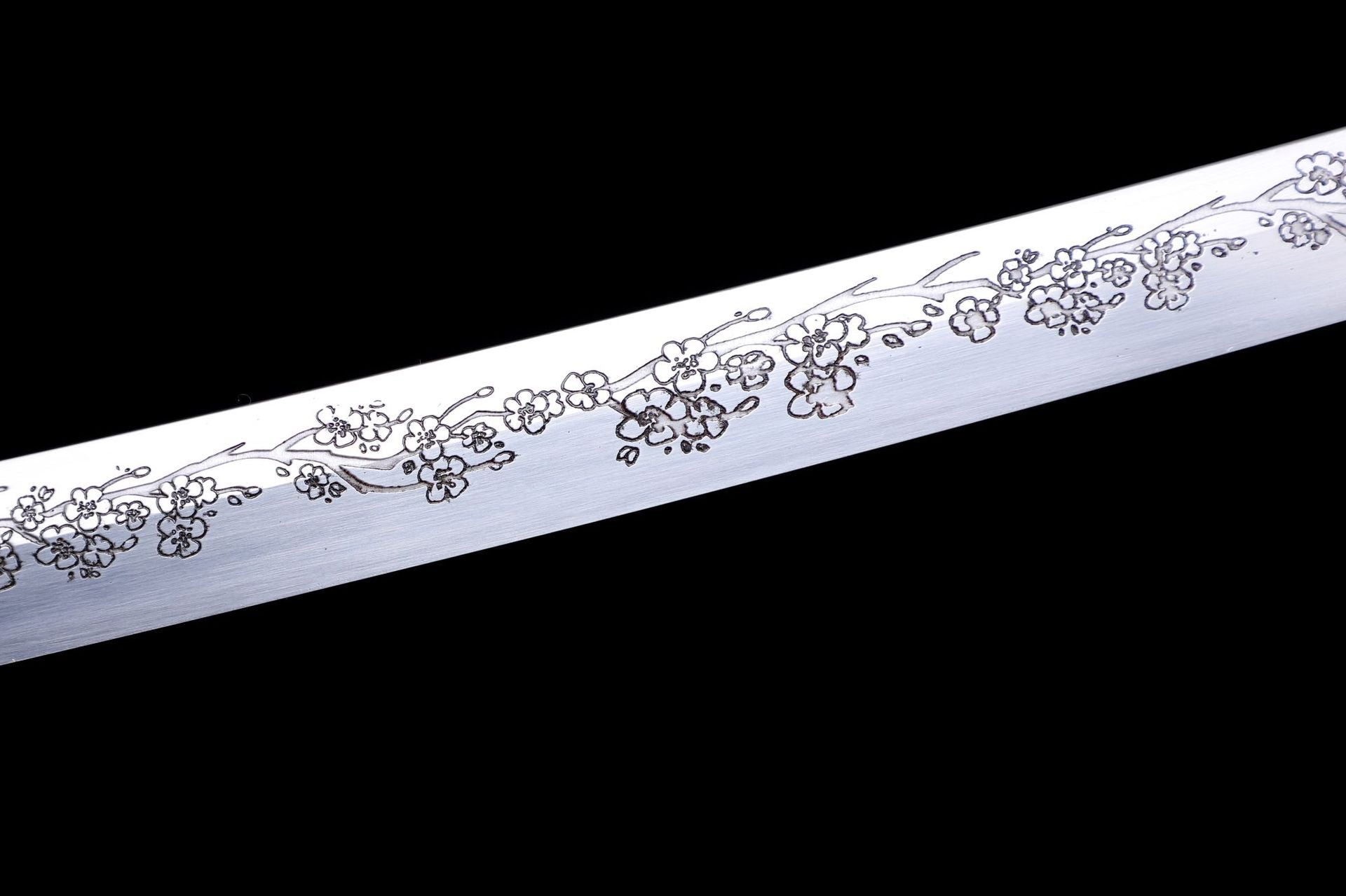 Close-up of sakura engraved blade, showcasing detailed sakura design.
