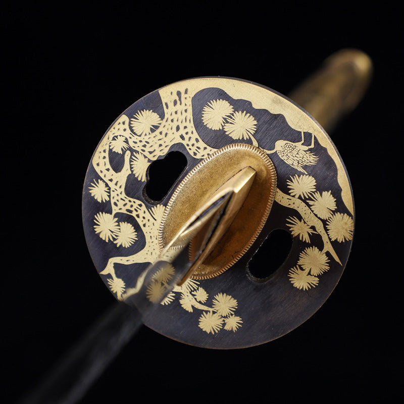 Close-up of sakura tsuba with sakura tree design, showcasing intricate gold inlay details.
