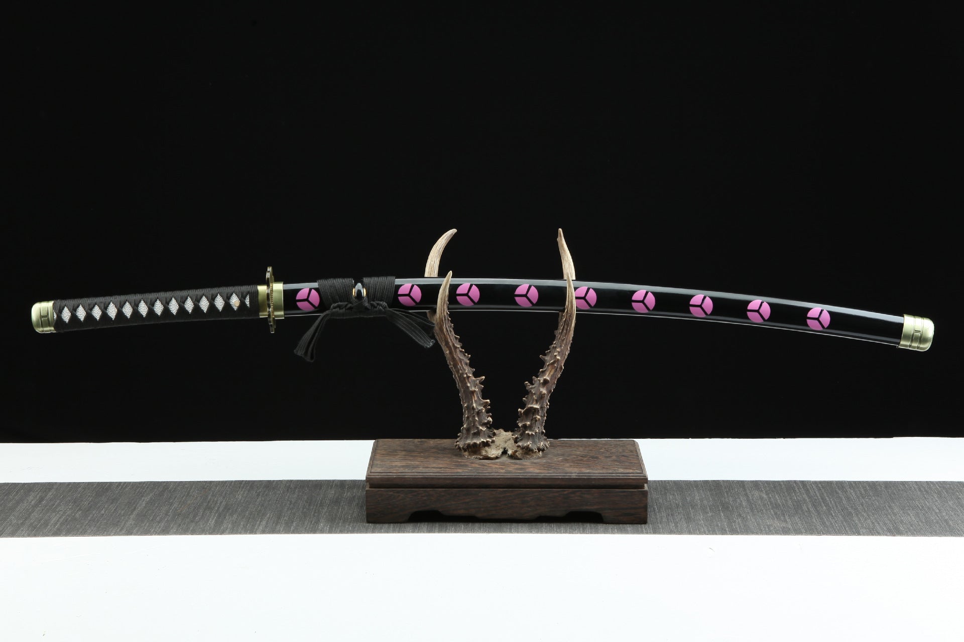 Shusui sword sheathed and displayed on a sword rack.