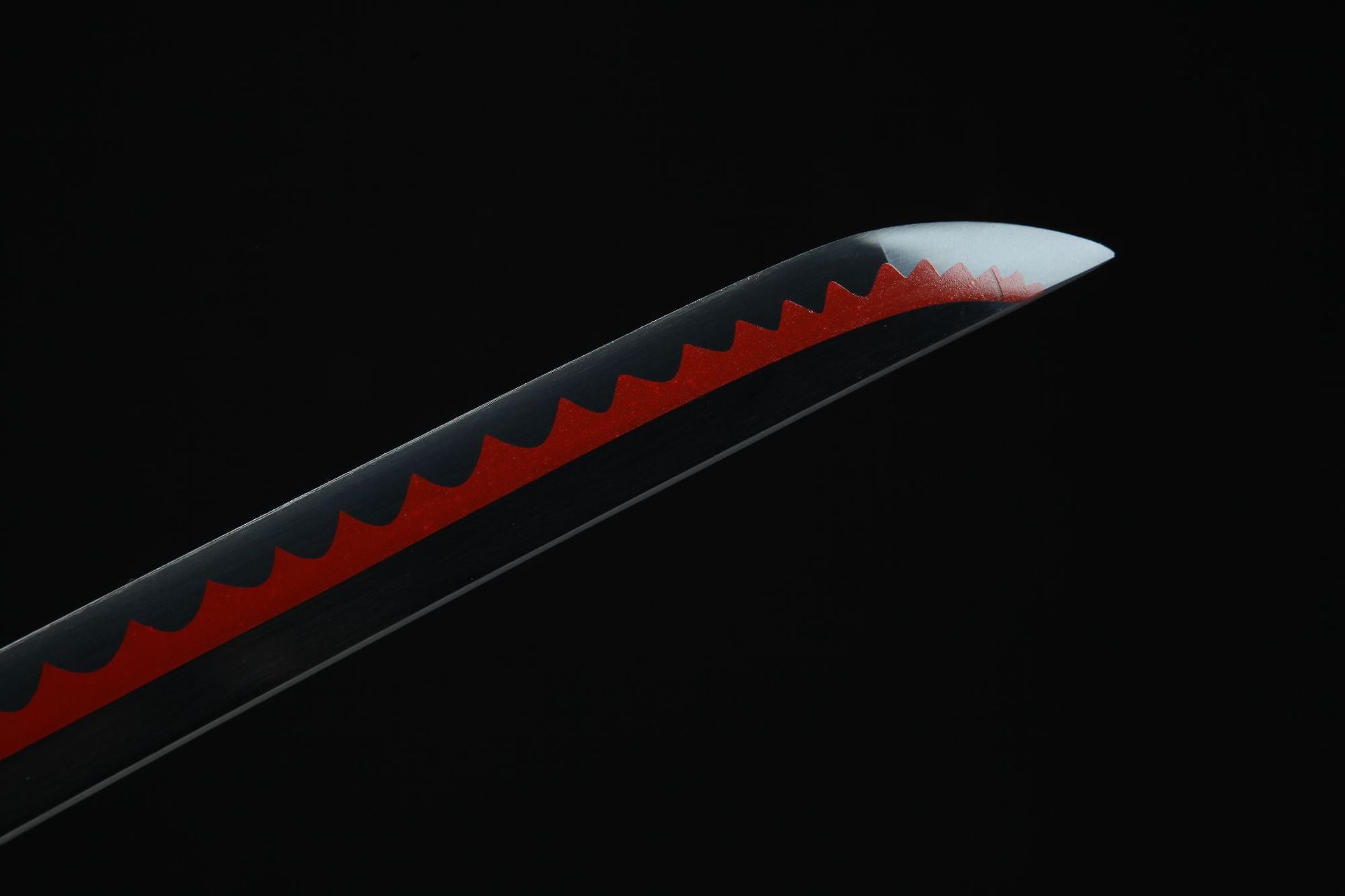 Detail of Shusui sword tip with red hamon pattern running from the tip along the blade.