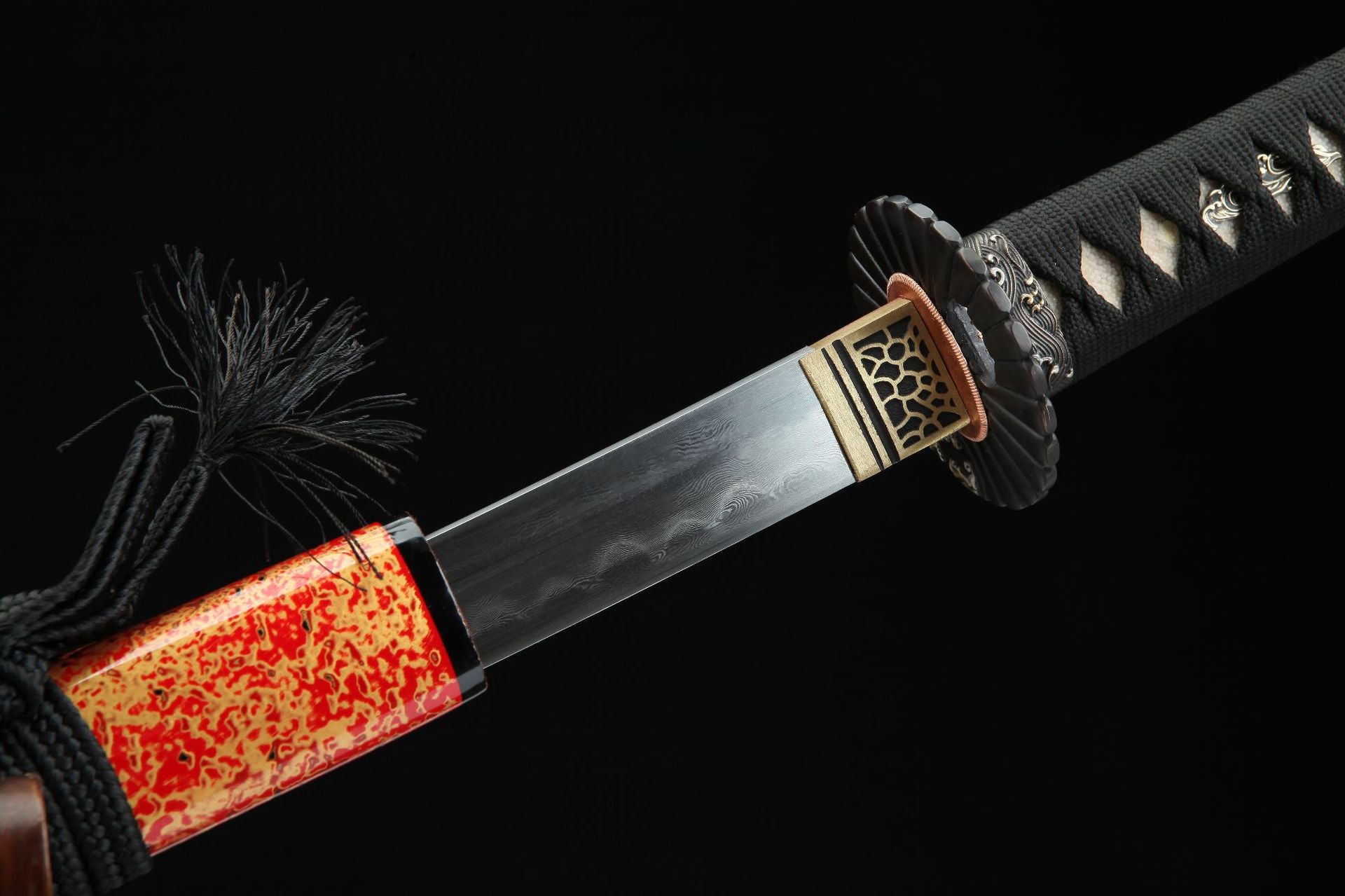 Close-up of the samurai sword showing the distinctive hamon and Damascus steel pattern on the blade.