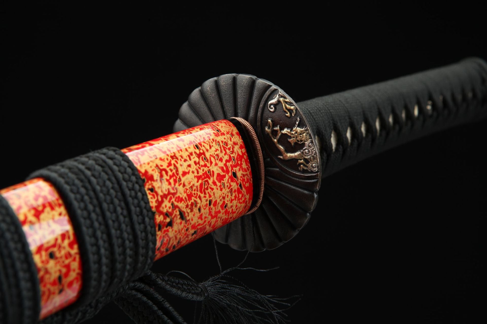 Close-up of the sunflower-themed tsuba on the samurai sword, showcasing intricate detailing and design.
