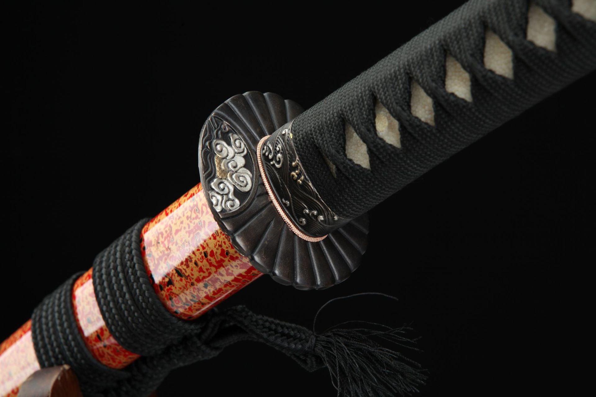 Close-up view of the samurai sword tsuba, featuring a sunflower design with intricate cloud patterns.