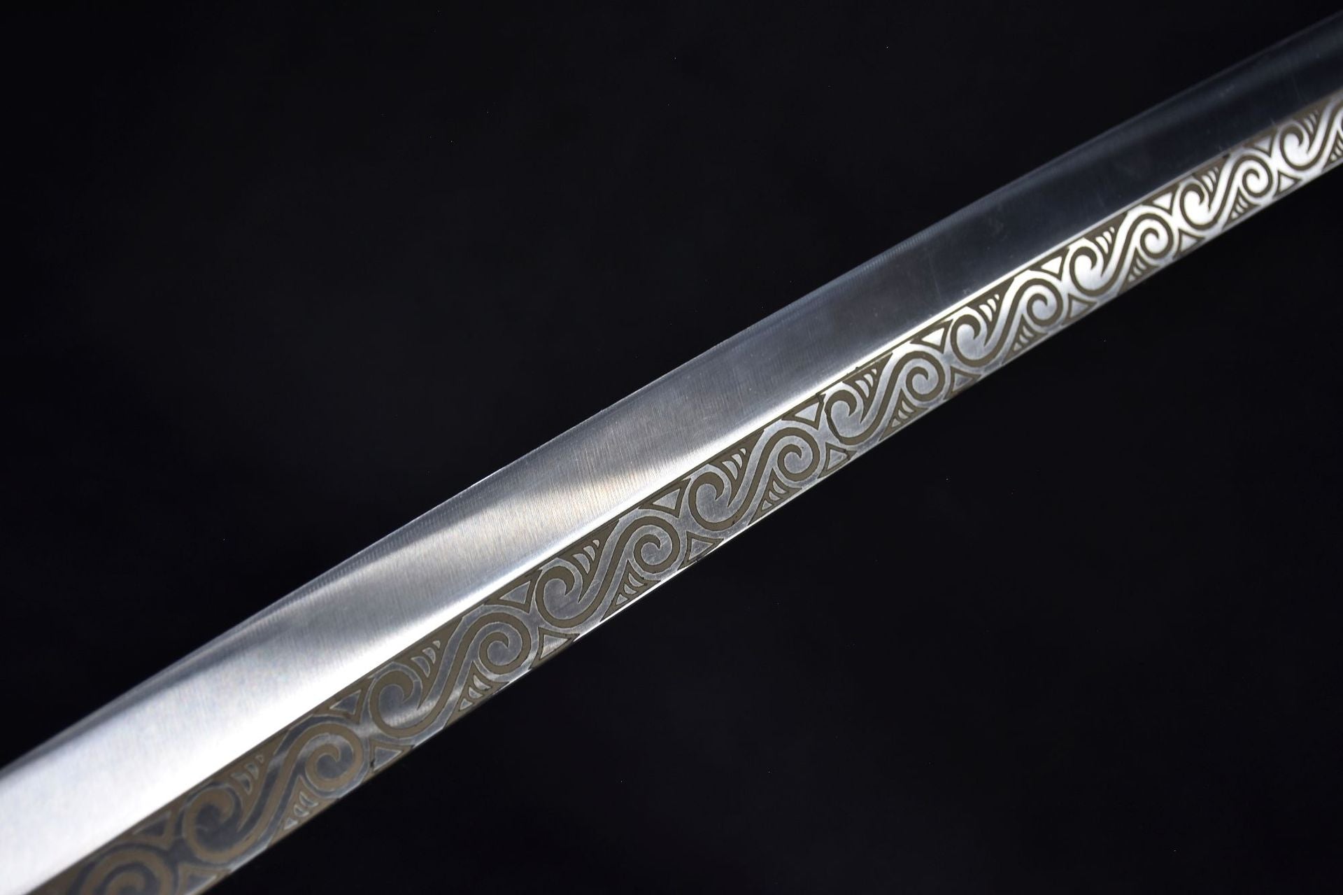 A katana blade with traditional patterns on its surface