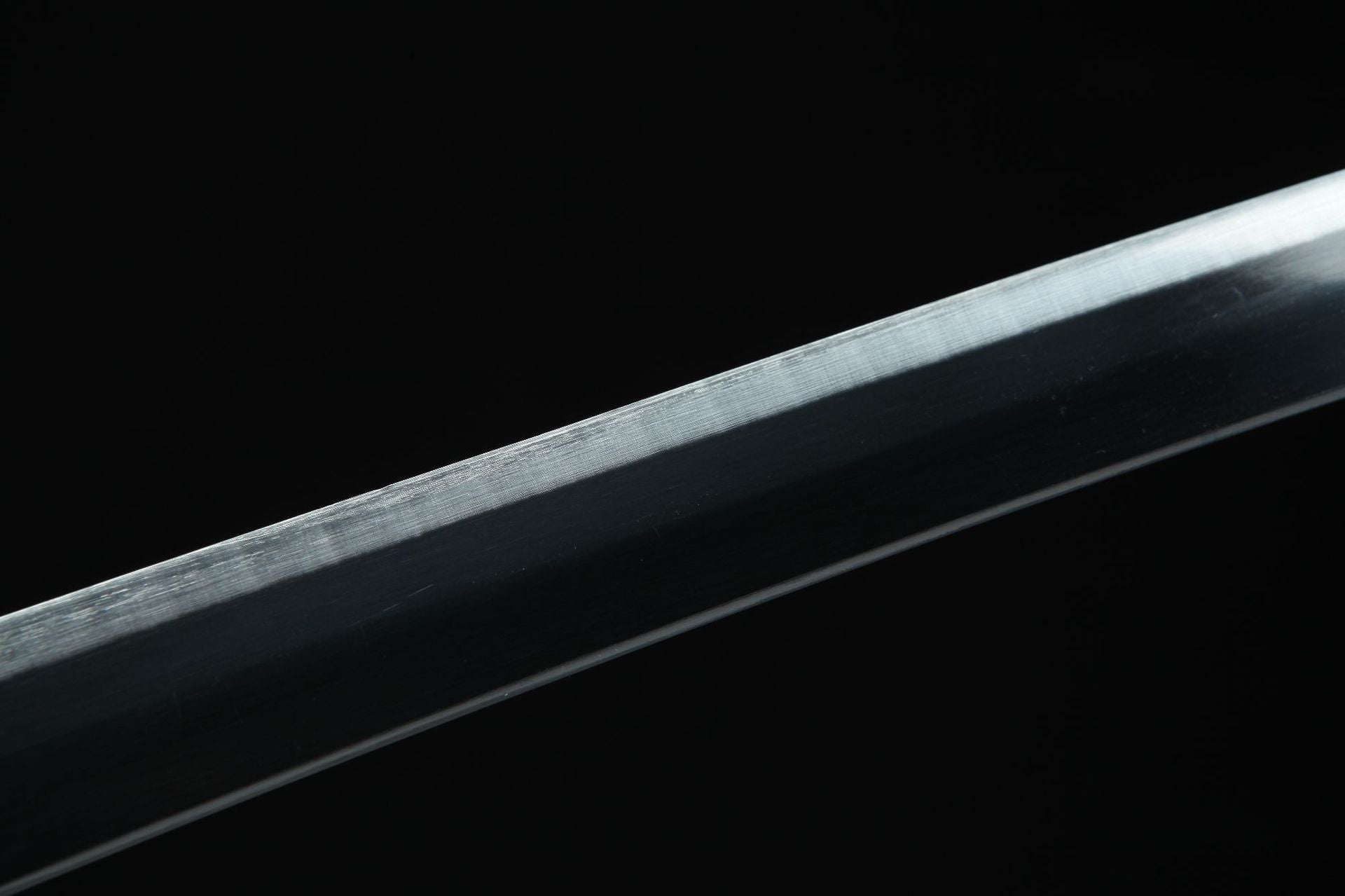 Close-up of Wado Ichimonji sword with white edge and black body.
