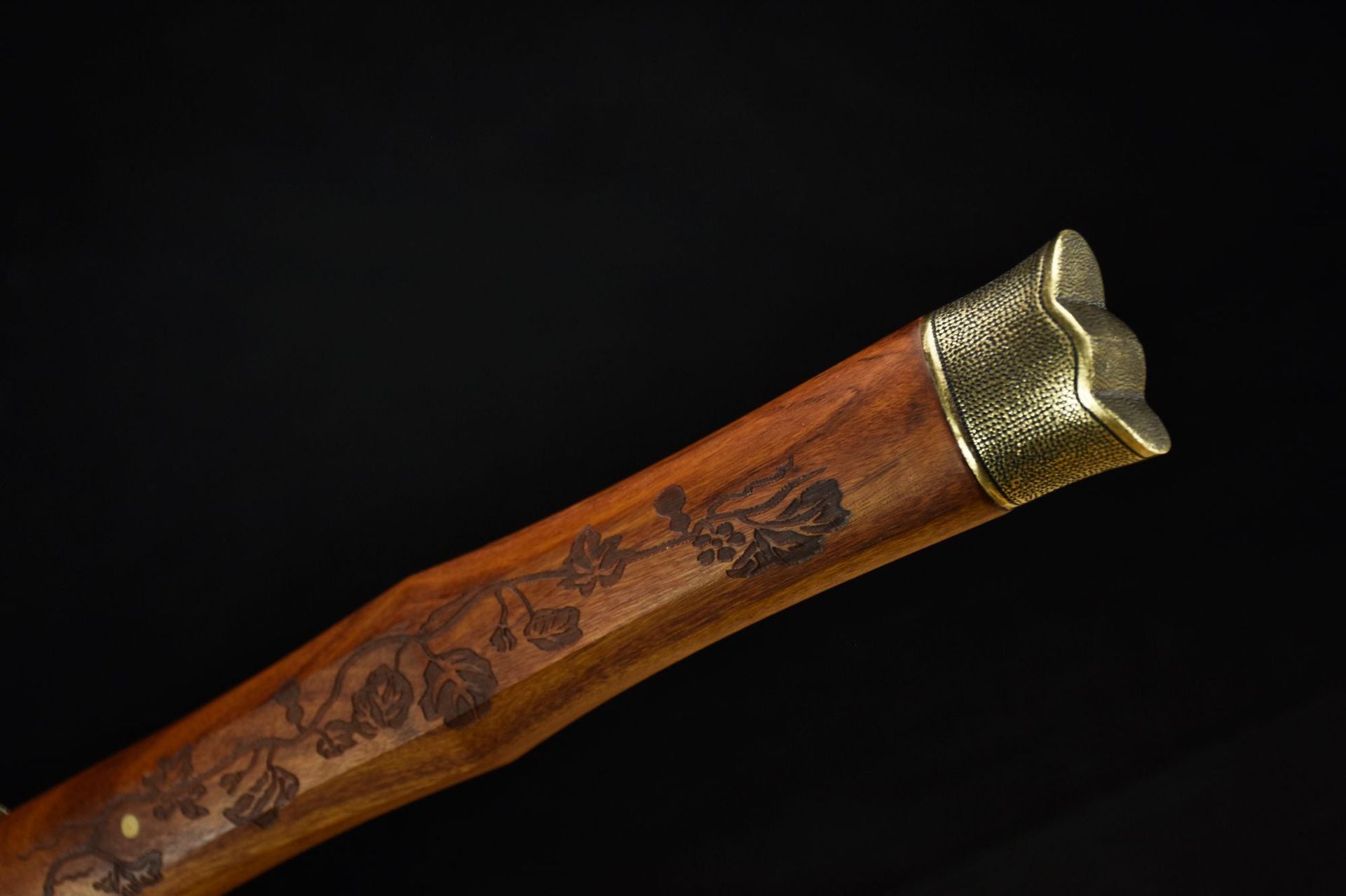 Close-up of the wooden katana handle featuring an exquisite gourd pattern, showcasing fine craftsmanship.