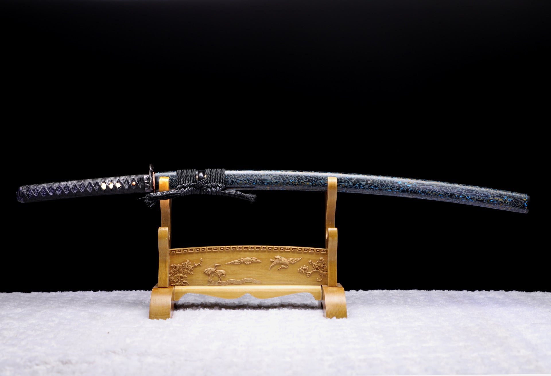 Full view of a samurai sword displayed on a stand, featuring the complete koshirae including all components.