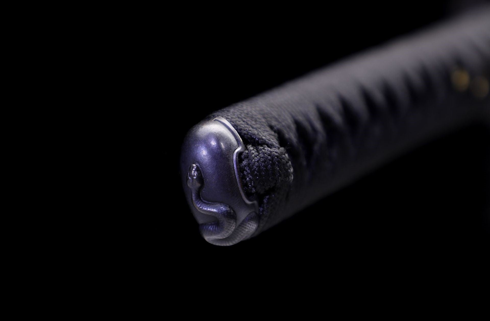 Close-up of the samurai sword's pommel (kashira) featuring a serpent design.