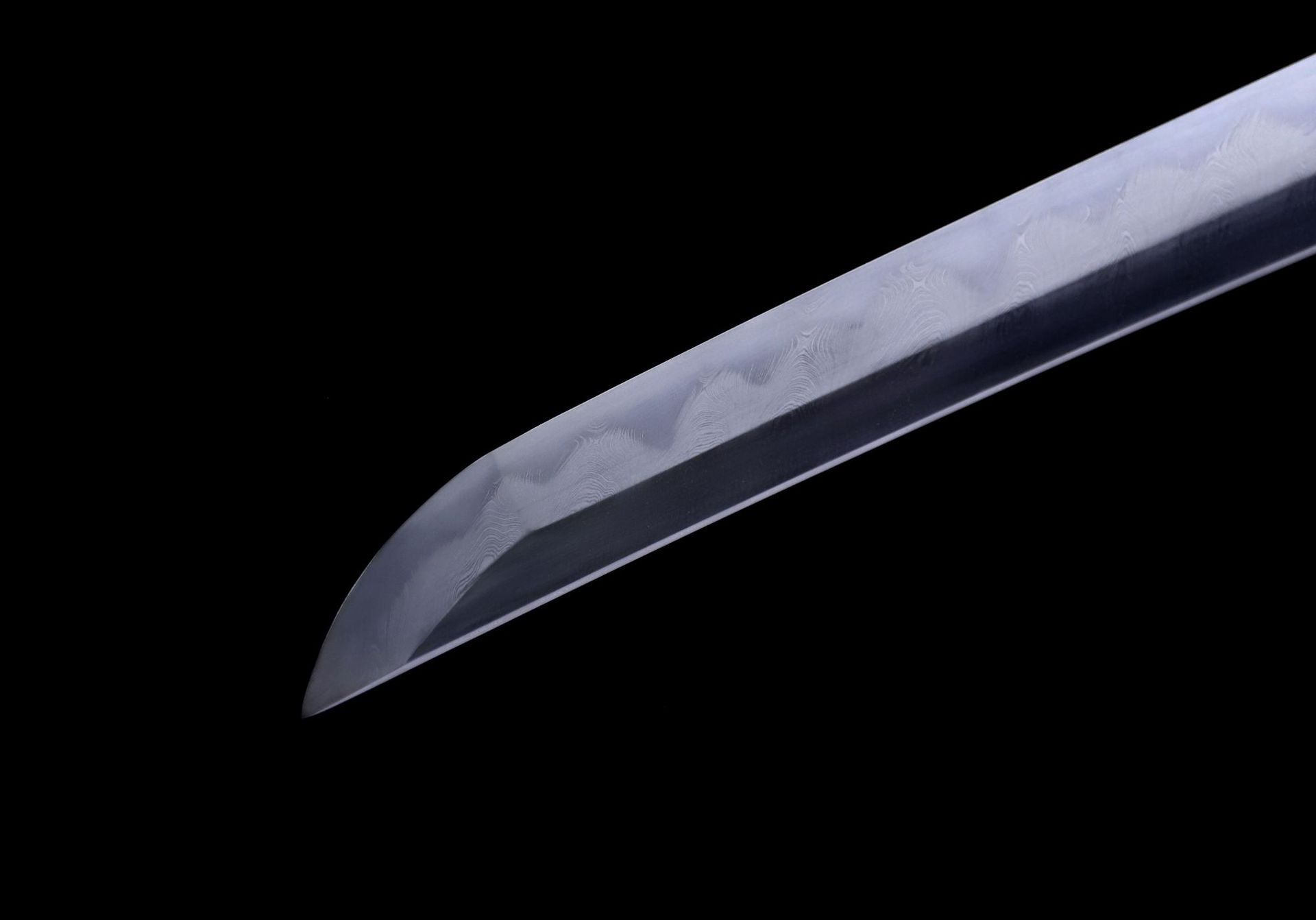 Close-up of the tip of a samurai sword (kissaki) showing the distinctive gunome pattern hamon.