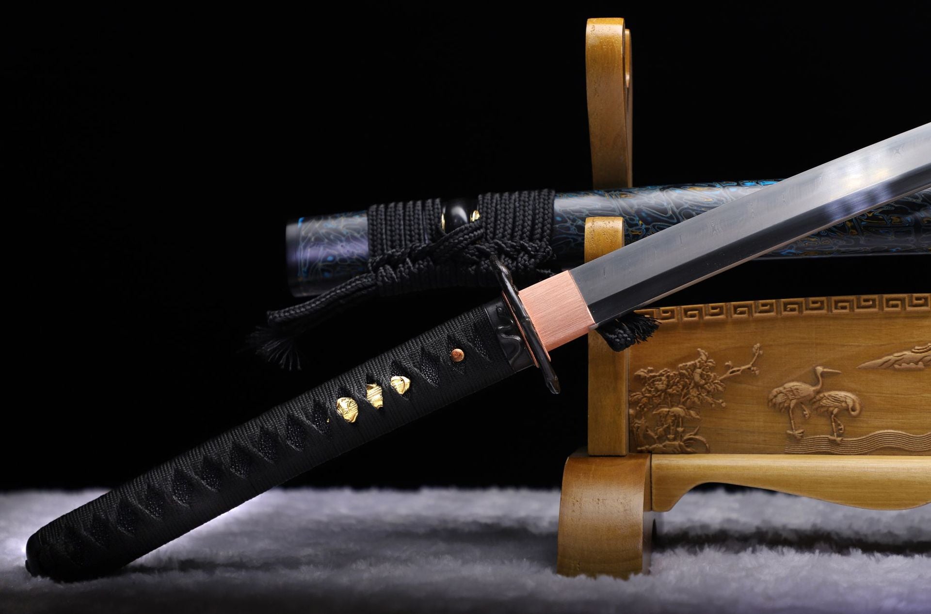 Detailed view of a samurai sword handle (tsuka) featuring traditional black tsukamaki wrapping.