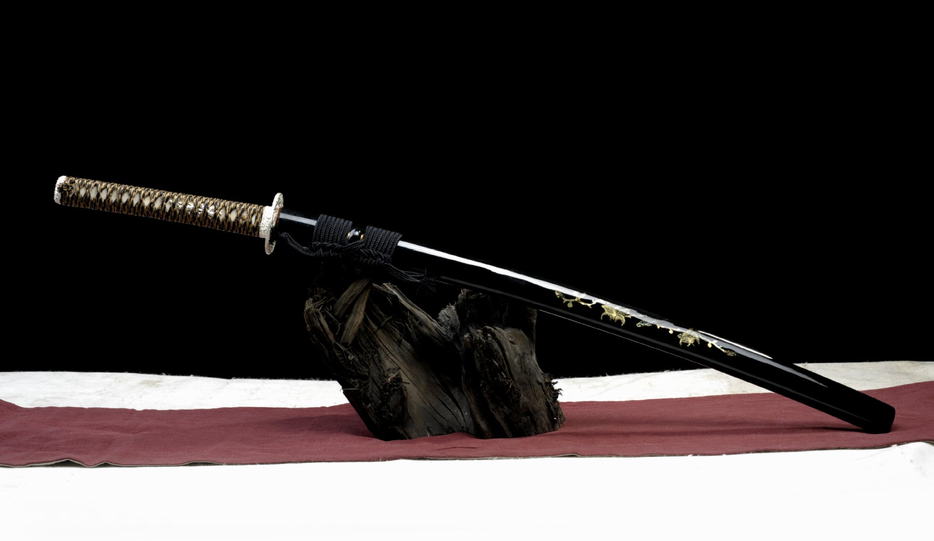 Black sword mountings inlaid with shell pieces and buffalo horn.