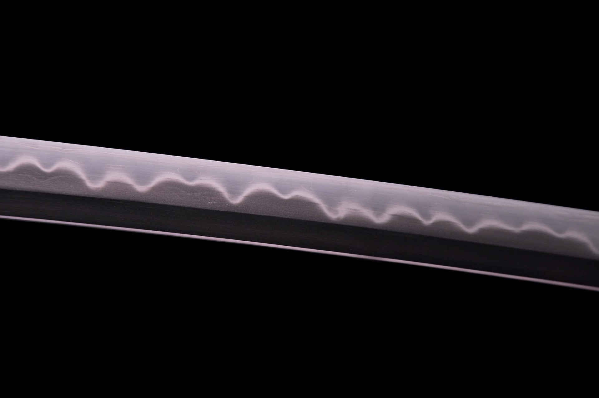 Final polish of katana blade with clear temper line.
