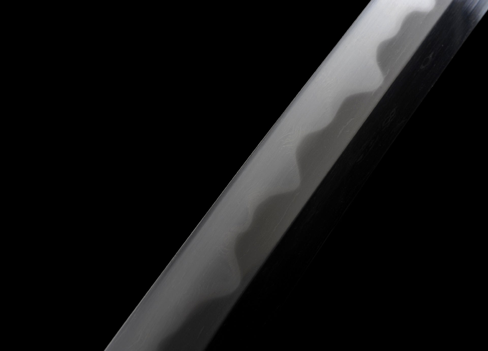 Final polish of a katana blade with a clear gunome hamon.