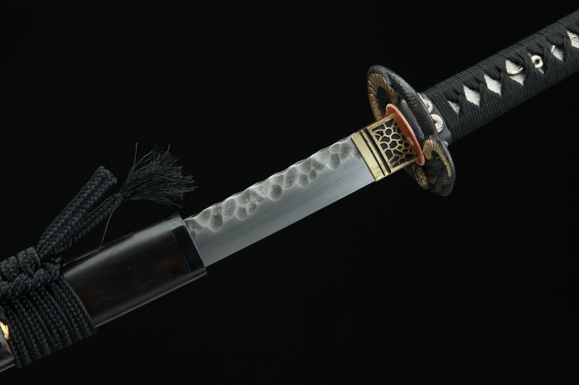 Detailed view of Hebi katana showing the blade near the tsuba and habaki.