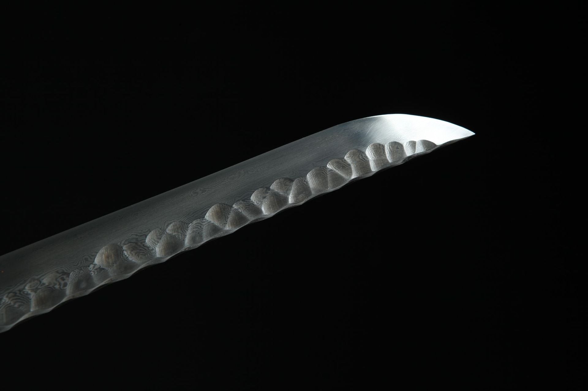 Close-up of Hebi katana tip showcasing the distinctive pattern of Damascus steel.