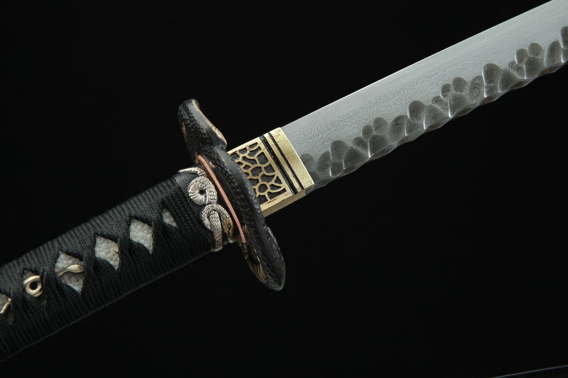 Detailed side view of Hebi katana's fuchi and tsuba, showcasing snake design elements.
