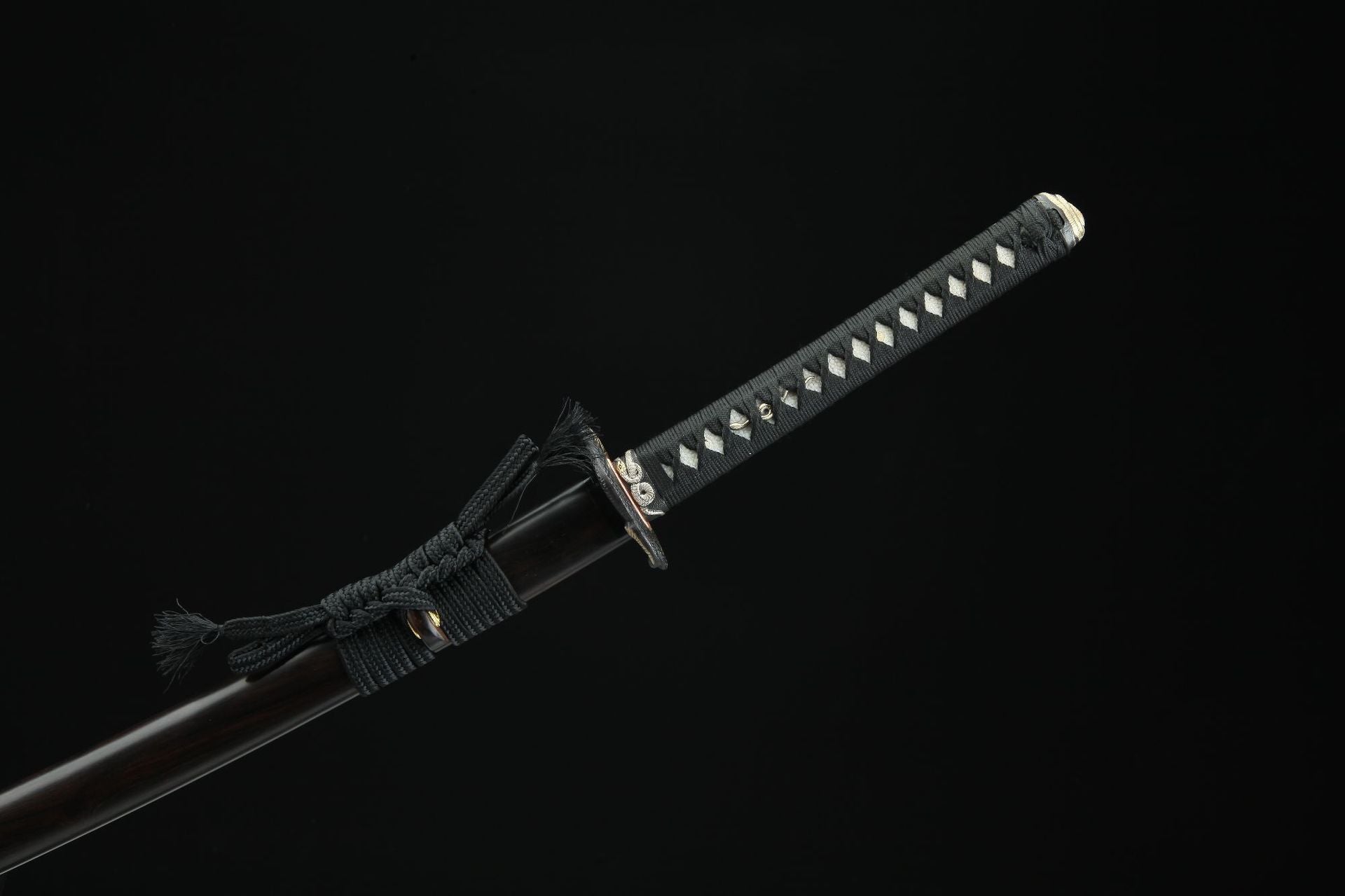 Hebi katana handle wrapped in black cord with a smooth scabbard, emphasizing traditional craftsmanship