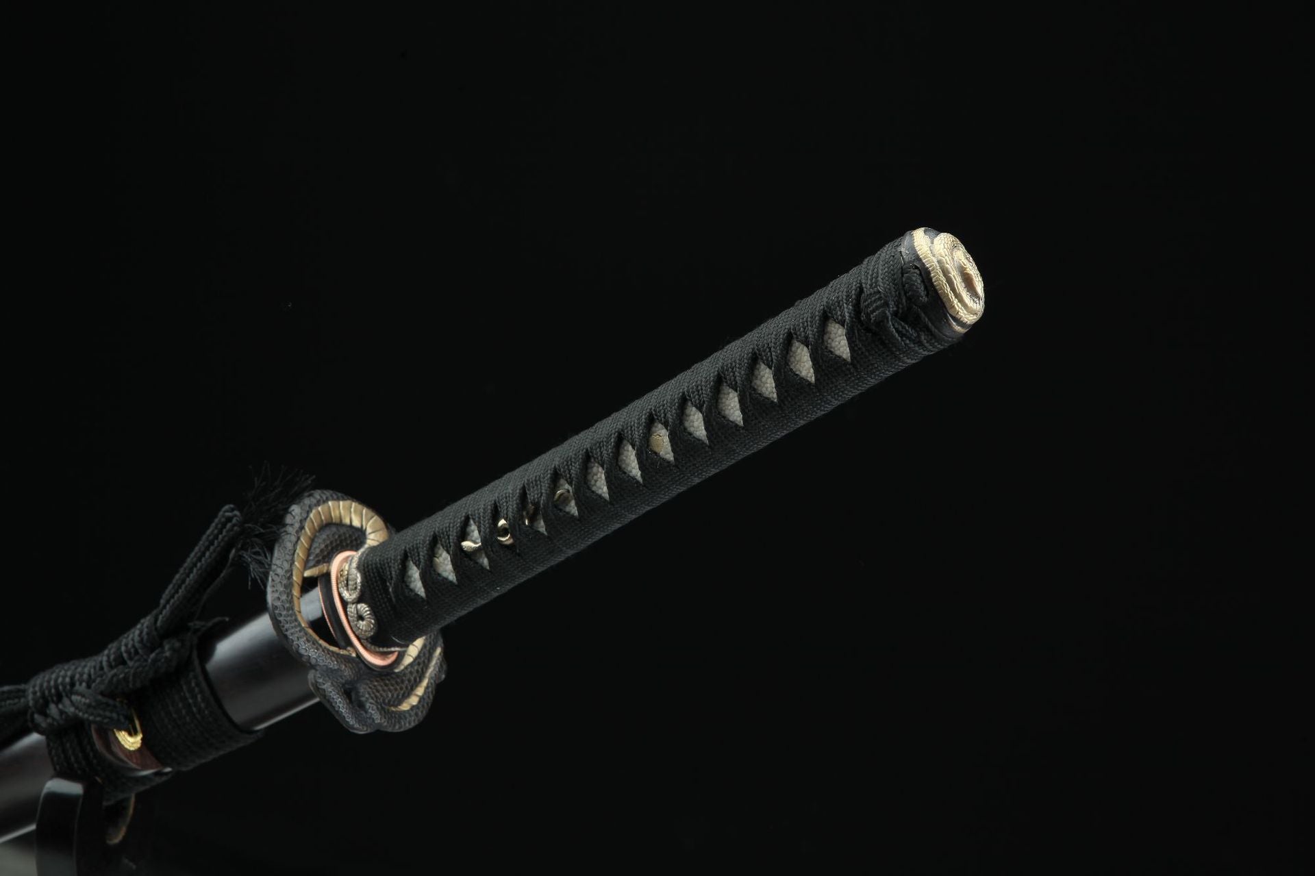 Close-up of Hebi katana handle showing detailed cord wrapping and end cap.