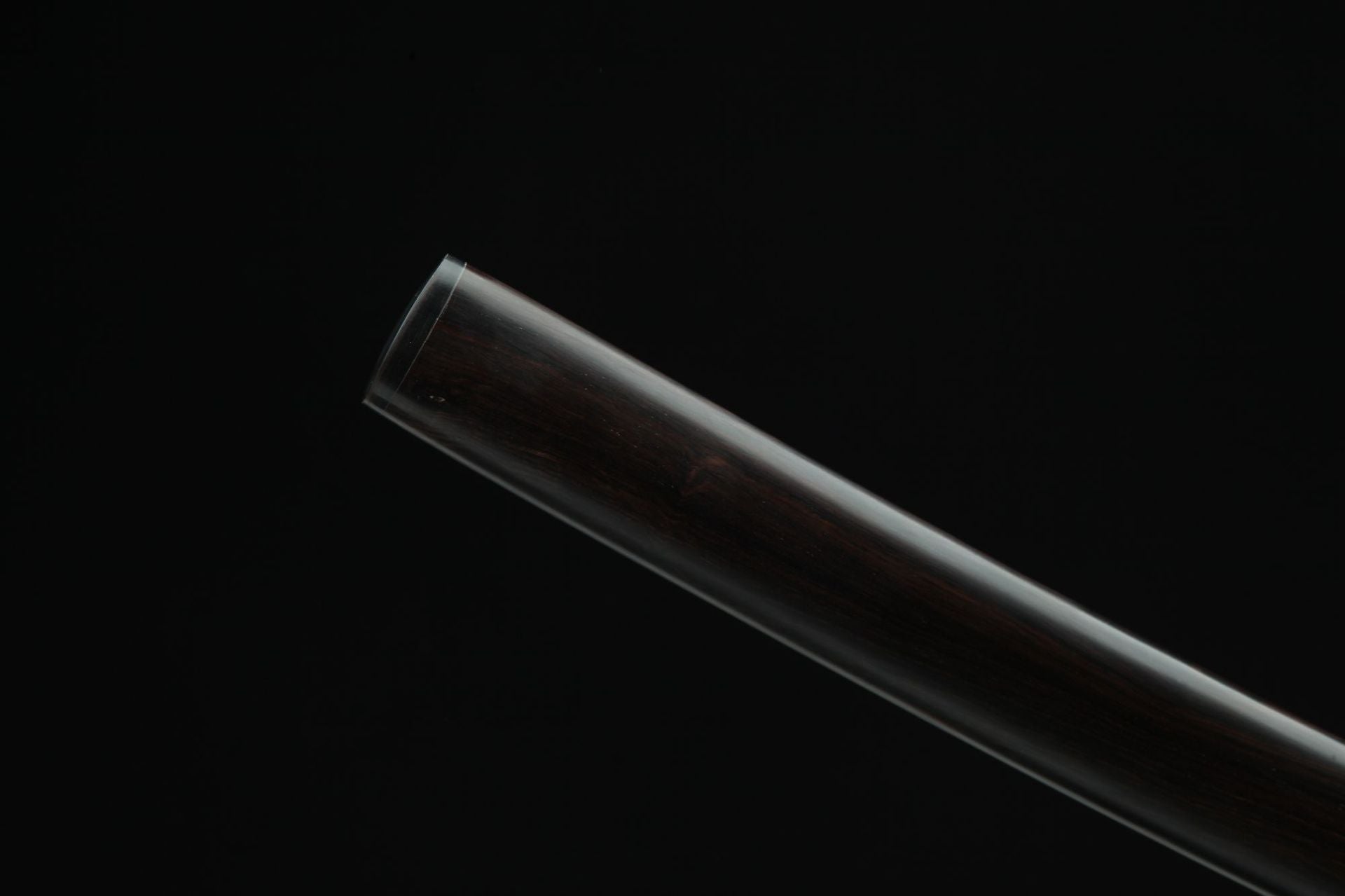 Close-up view of the Hebi katana kojiri and the quality and texture of the wood saya.