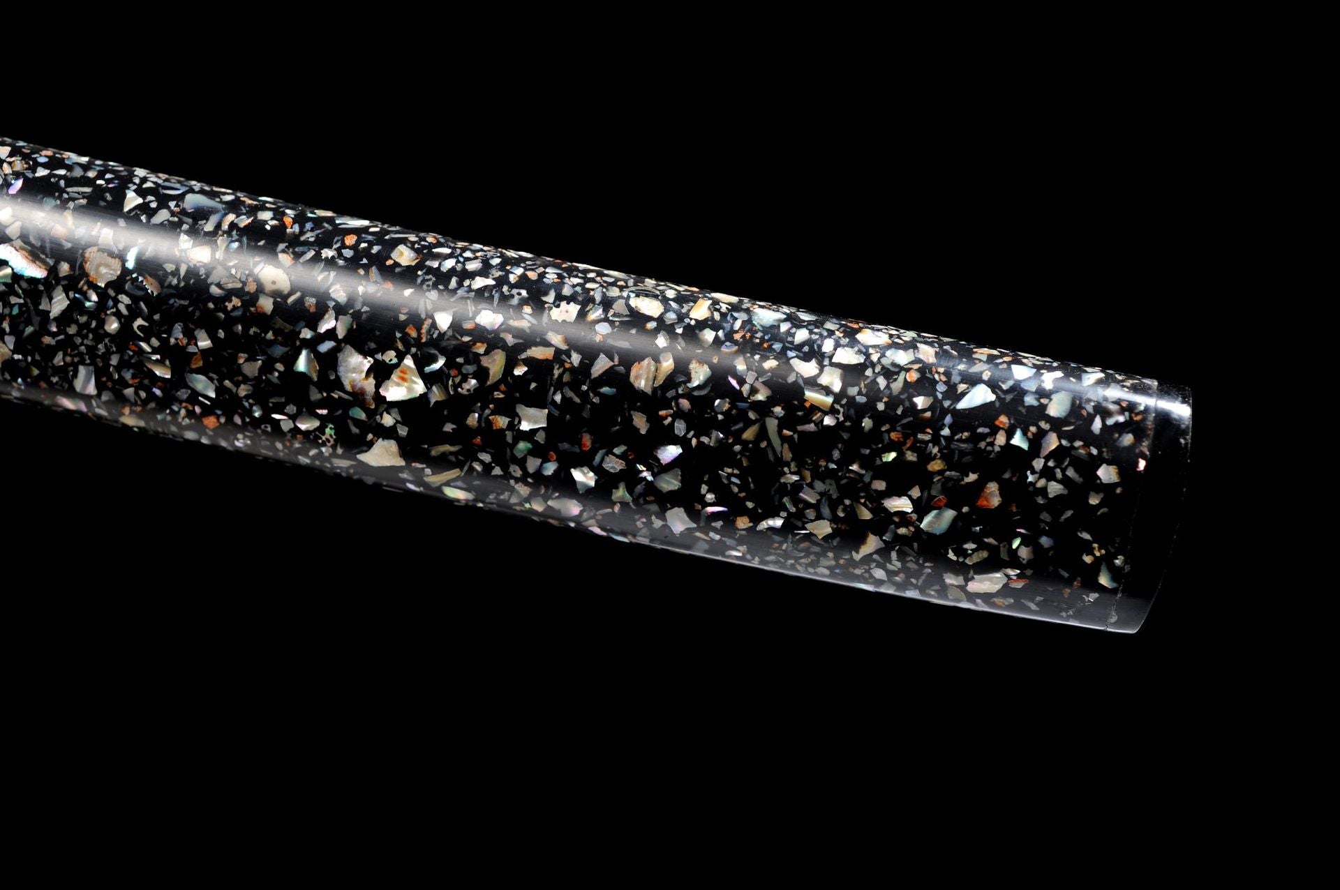 Black katana scabbard with inlaid shell pieces.