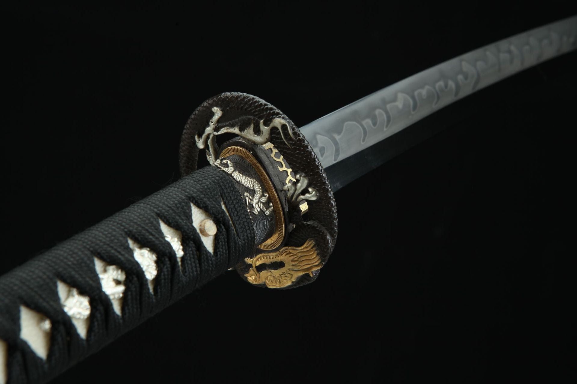Close-up view of the Loong Clow katana's tsuba featuring a detailed loong head design.