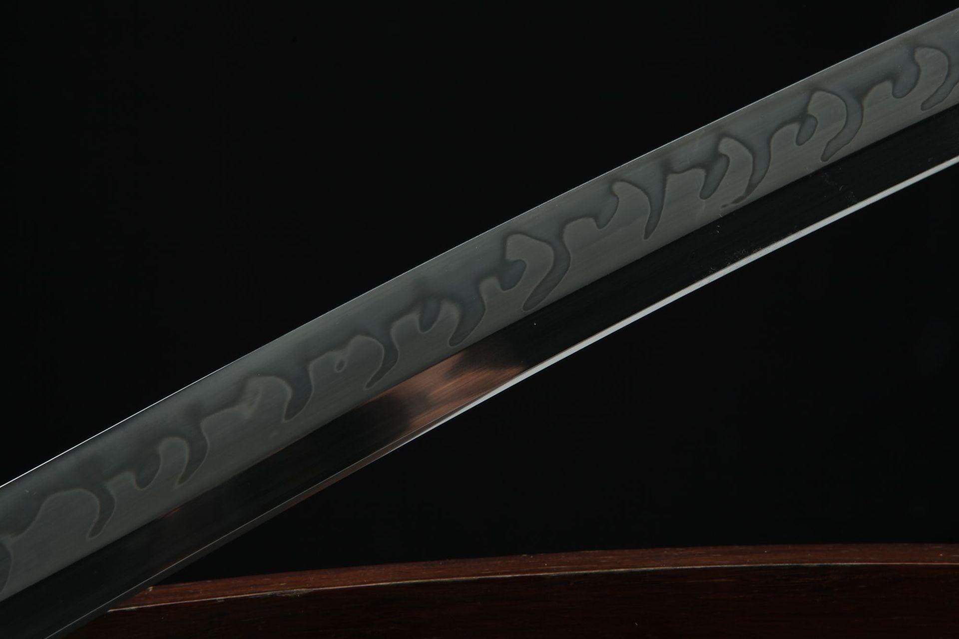 Close-up view of the Loong Clow katana's blade featuring the hamon, the distinctive wavy pattern, and the hiraji, the polished flat surface.
