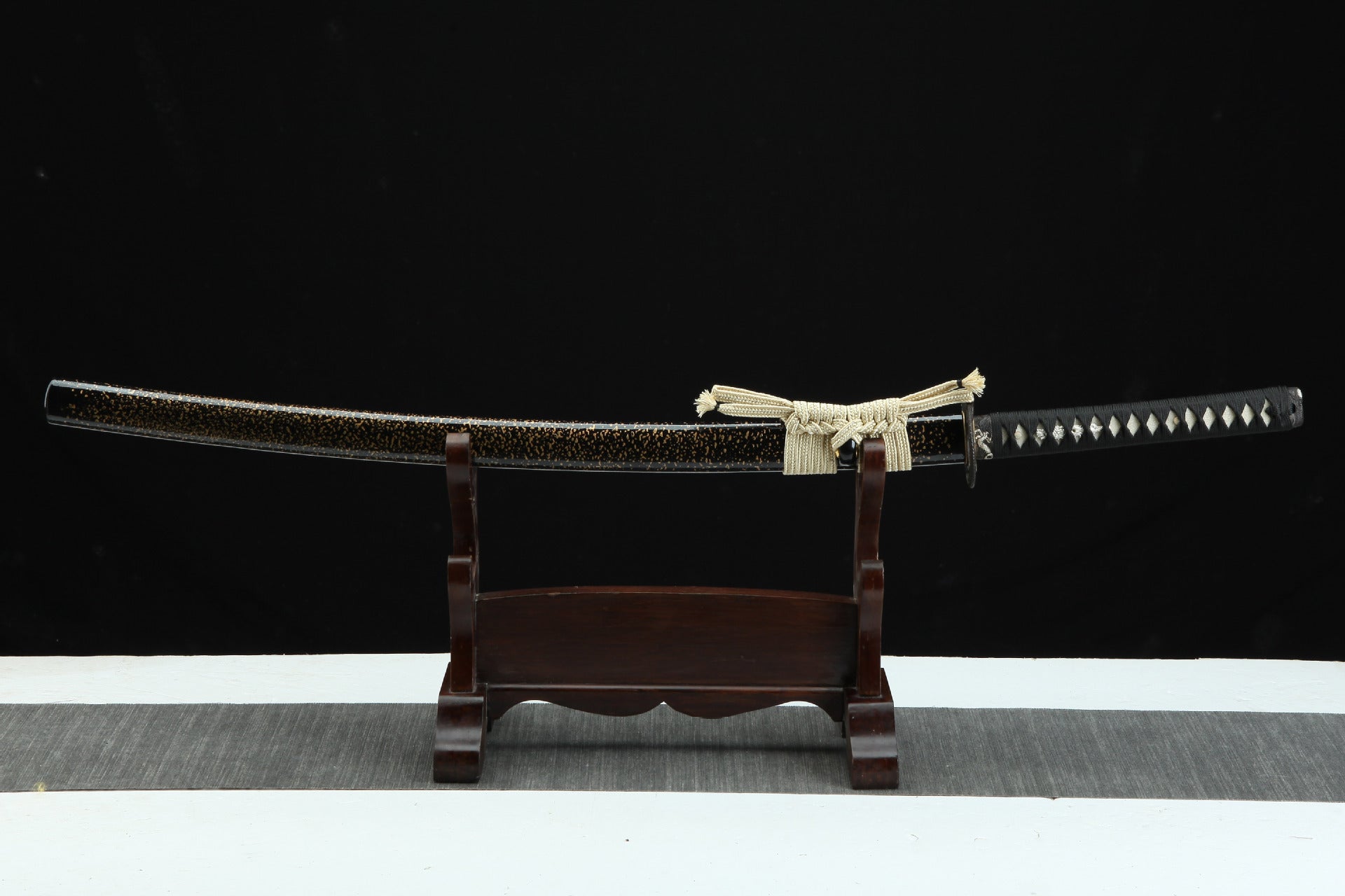 Full koshirae display of the Loong Clow katana on a traditional wooden stand, showcasing the entire assembly of the sword including the lacquered scabbard, the woven sageo, and the intricately designed tsuka.