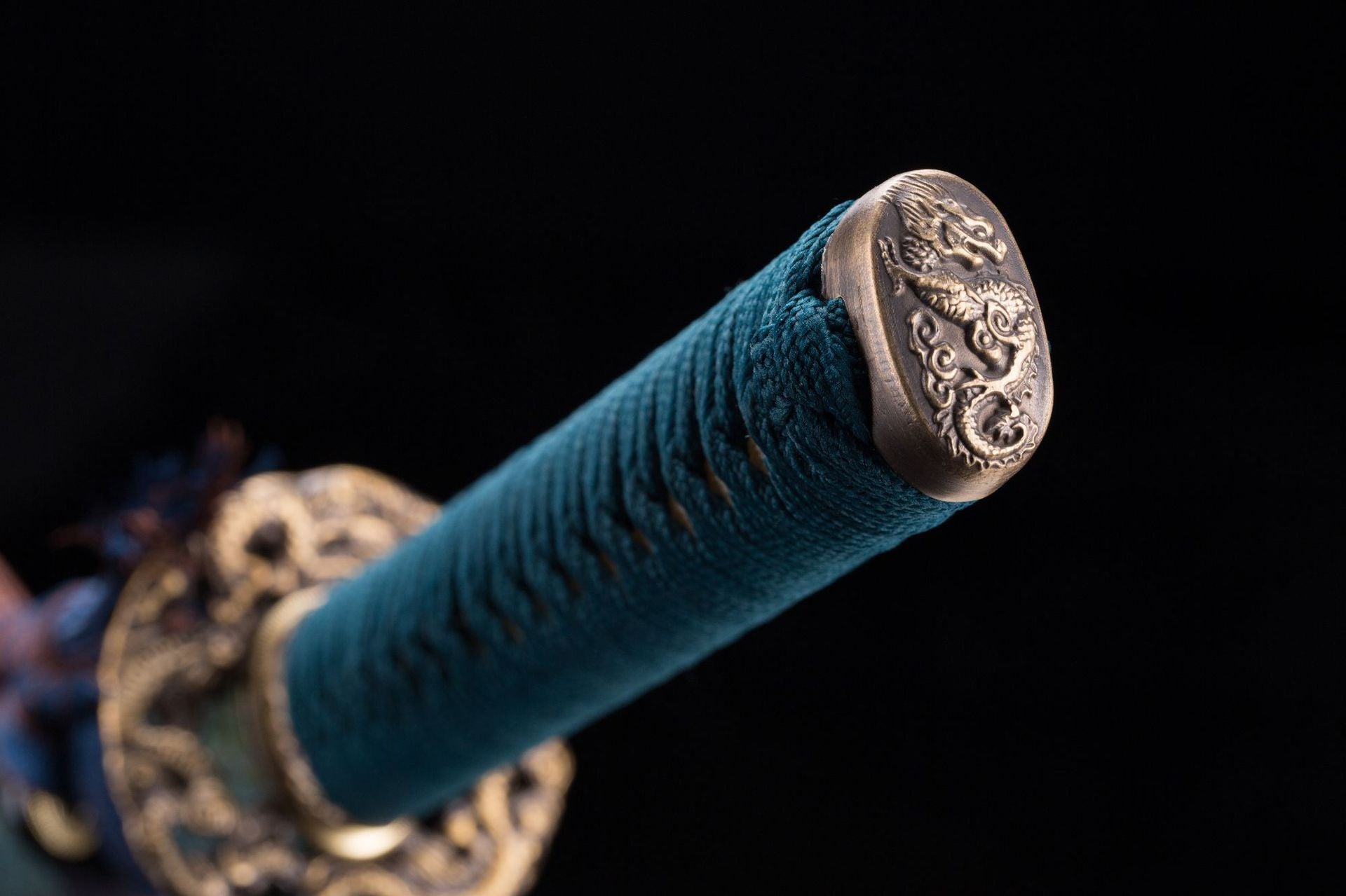 A close-up view of a kashira intricately engraved with a loong motif, highlighting fine craftsmanship and traditional Japanese artistry.