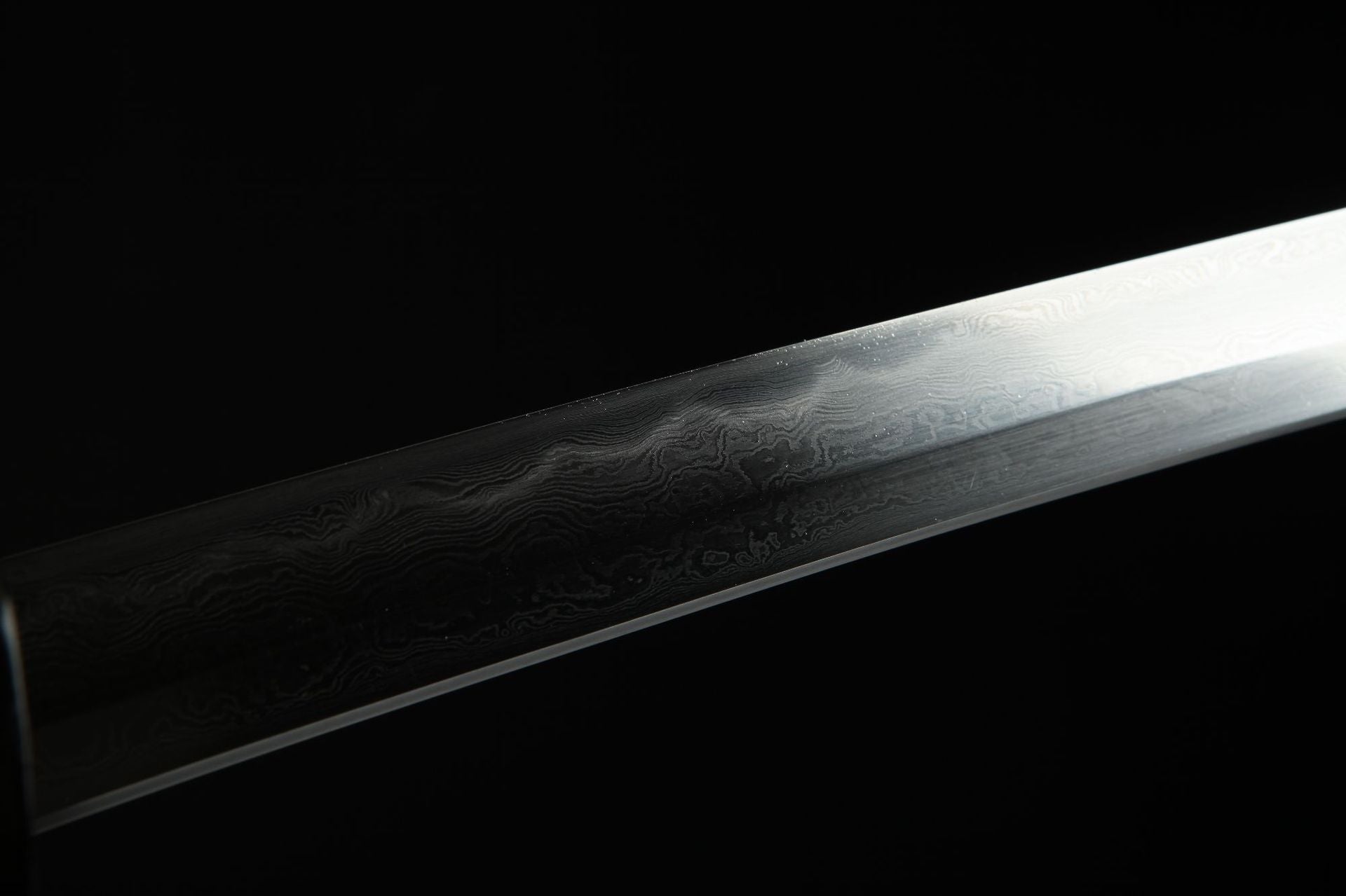 Close-up of the Lotus katana's Damascus steel blade featuring a distinctive clay-tempered hamon.