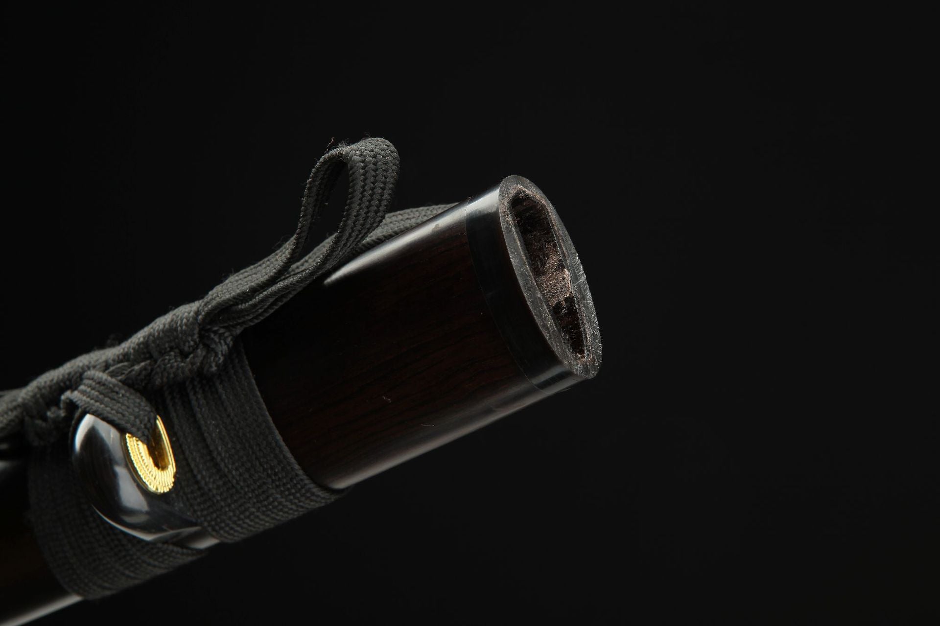 Close-up of the Lotus katana's koiguchi and kurigata, highlighting the detailed craftsmanship and fittings on the saya.