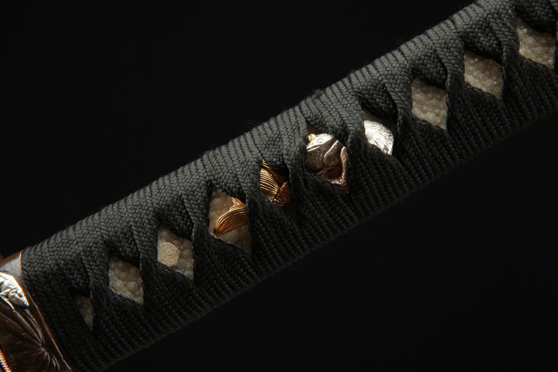 Detailed view of the Lotus katana's menuki featuring a lotus and toad design.