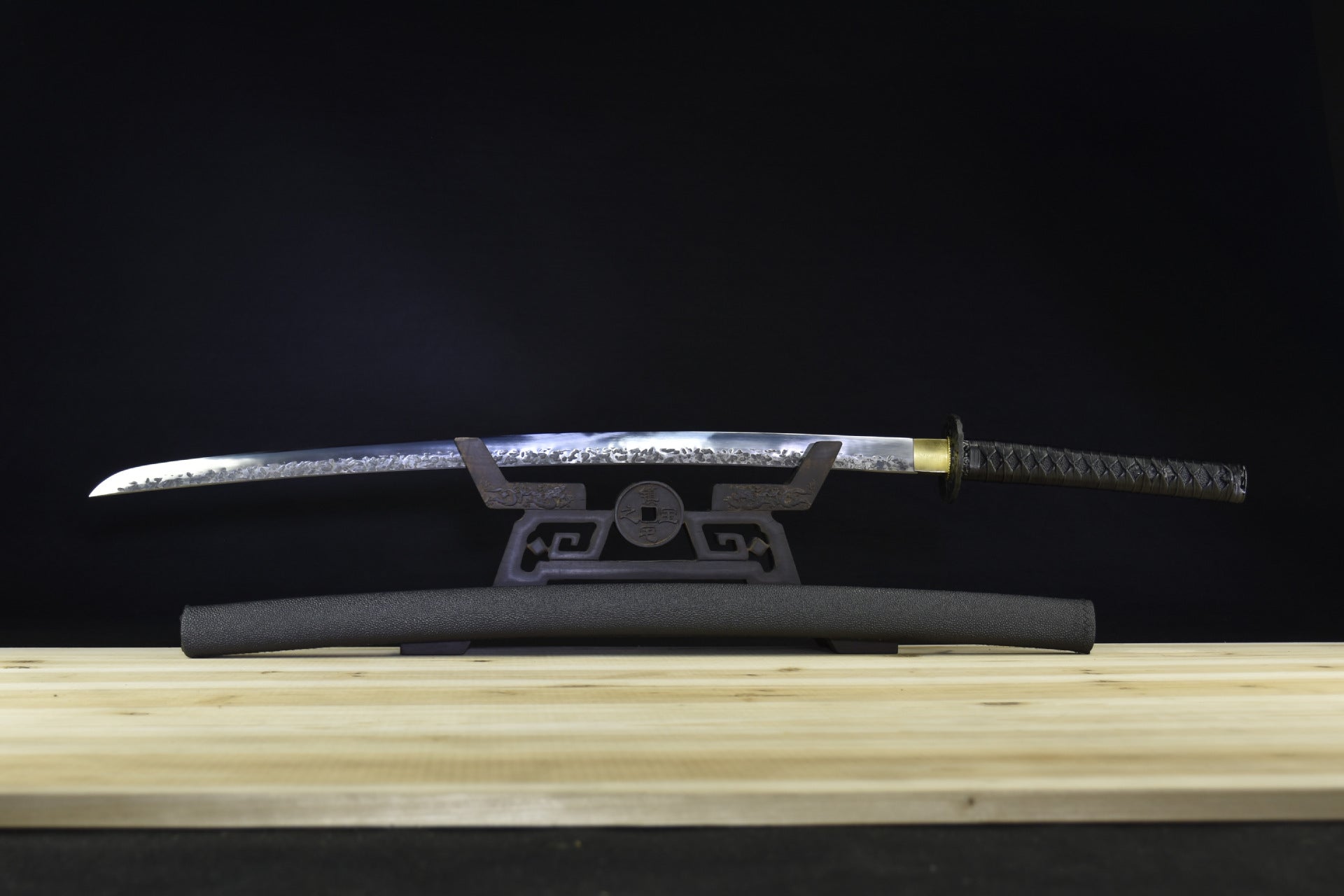 manganese steel katana for sale, featuring a traditional black saya.