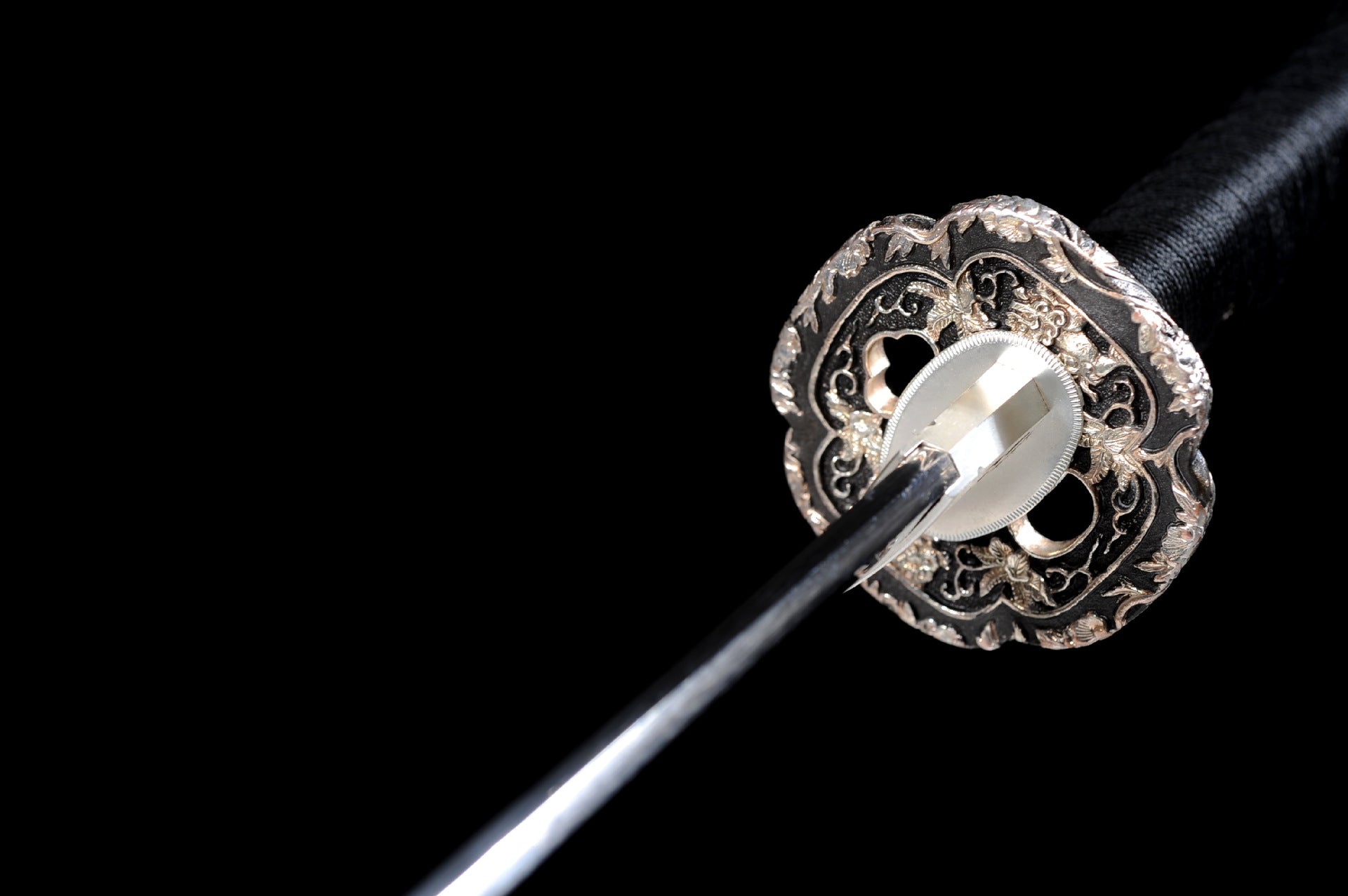 Silver-plated floral-engraved mokkō-gata tsuba on the katana.