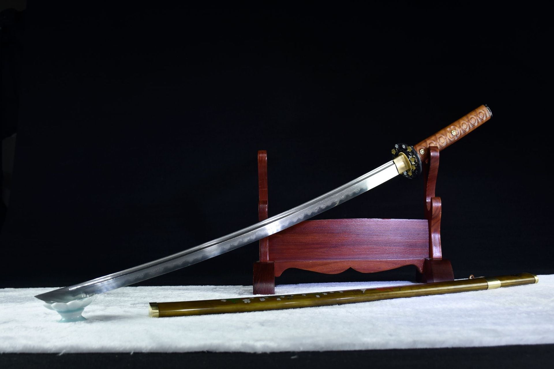 The overall display of the moonlit sakura samurai sword, showing the damascus blade and the sakura koshirae.