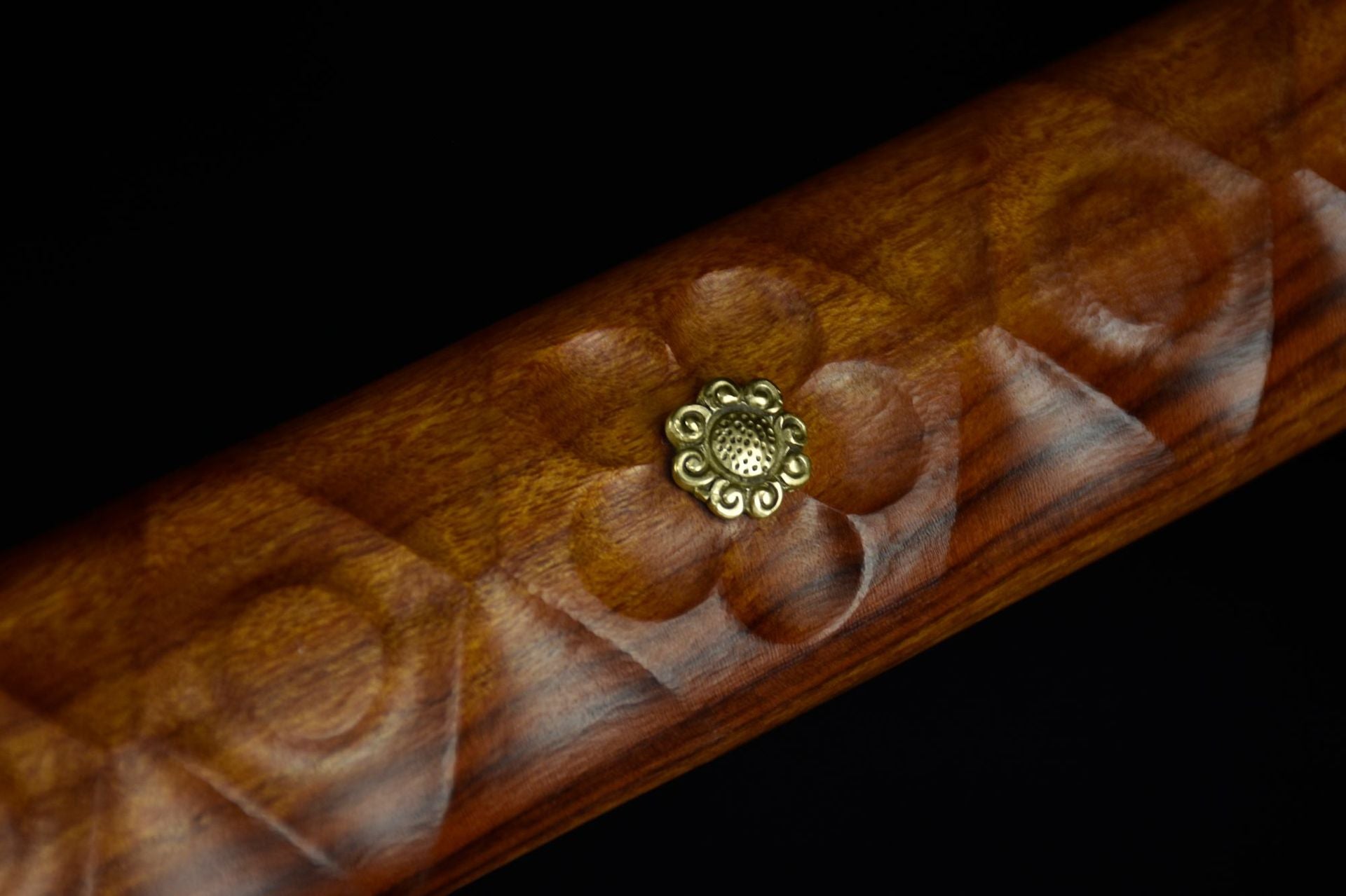 Moonlit Sakura samurai sword handle featuring intricately carved cherry blossom patterns.