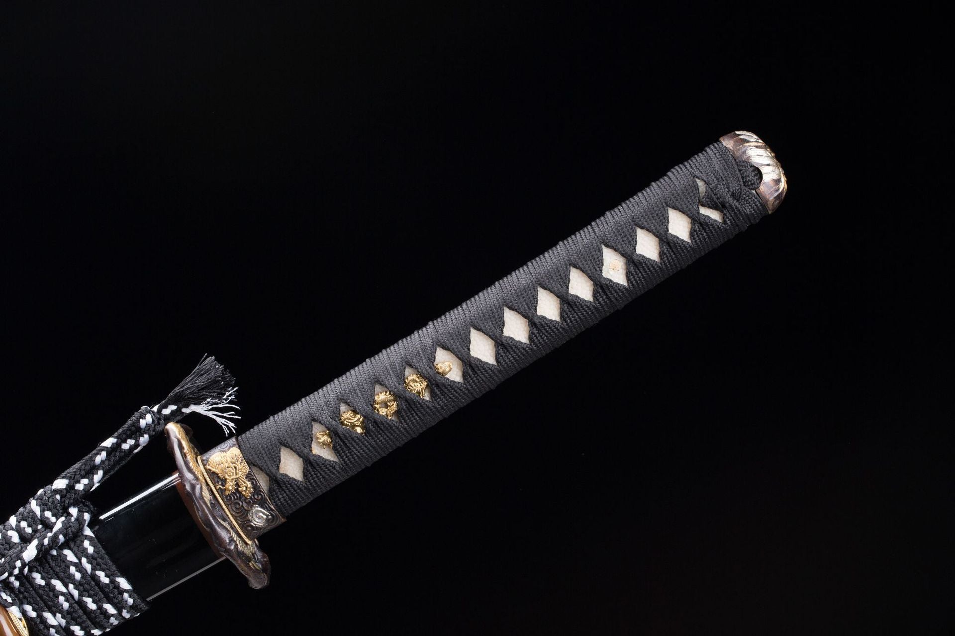 Full view of the Orochi katana's handle with white samegawa and black tsuka-ito.