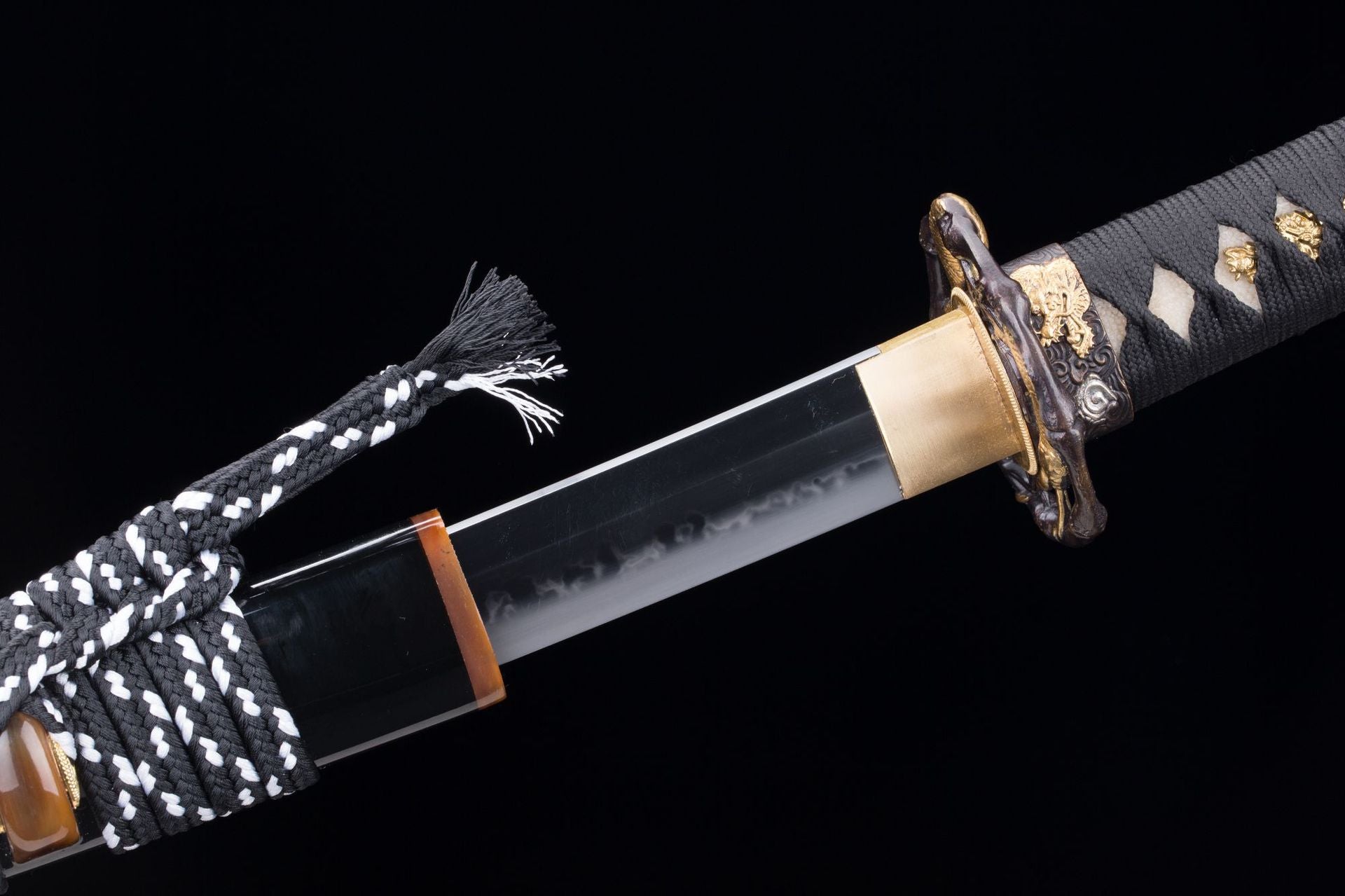 Detailed view of the Orochi katana's koiguchi made of buffalo horn.