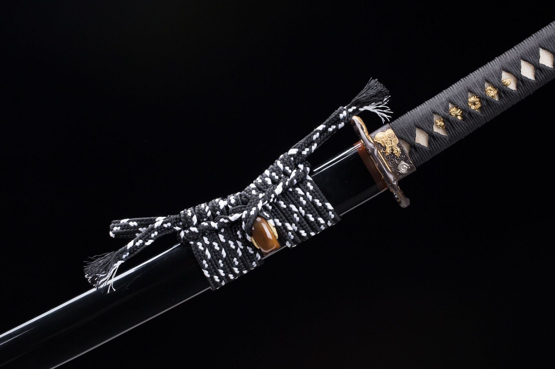 Close-up view of the Orochi katana's sageo, the traditional cord used to tie the sheath to the belt, showcasing the intricate weave and attachment to the scabbard.