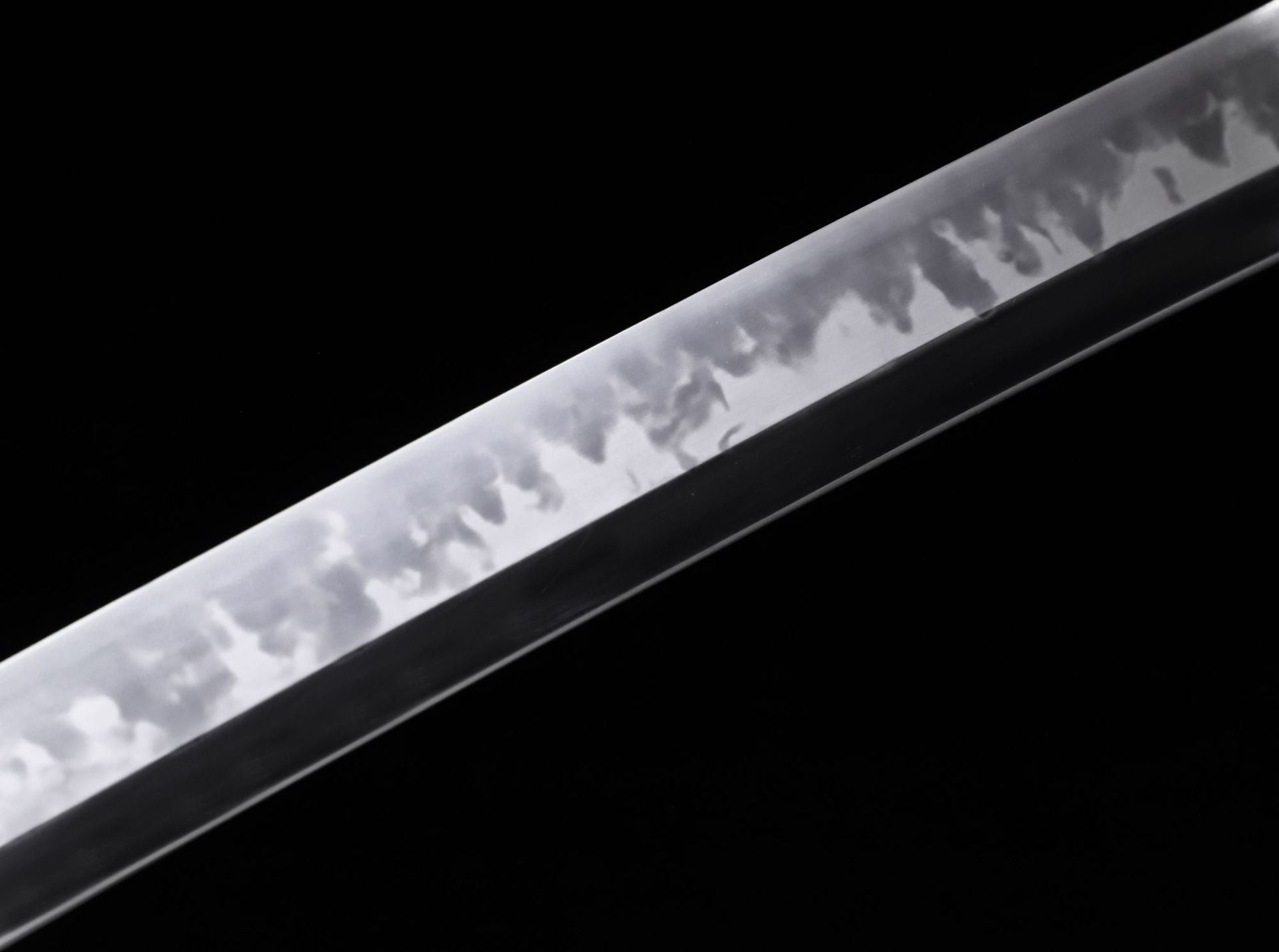 Close-up detail of the clay-tempered blade of a Phoenix samurai sword, highlighting the distinctive hamon.