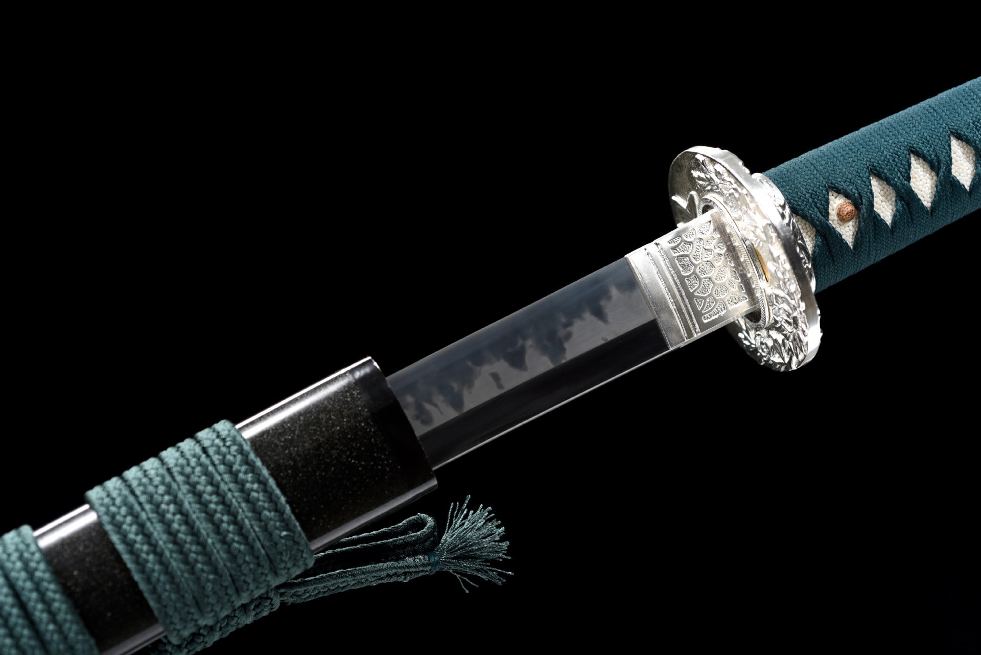 Close-up view of the fuchi and habaki on a Phoenix samurai sword.