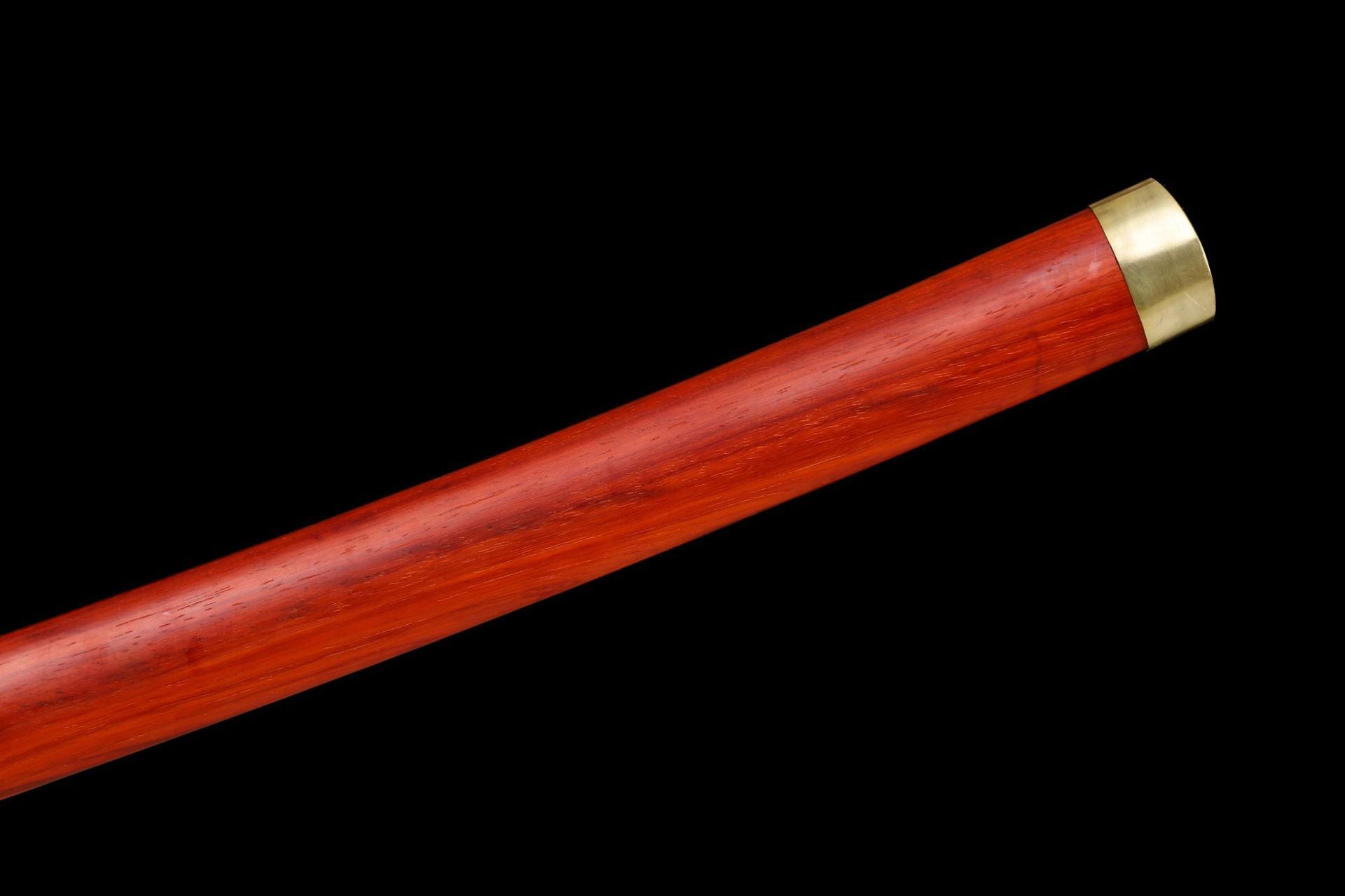 Closeup of the end cap of a red rosewood katana saya with a smooth finish and golden metal details.