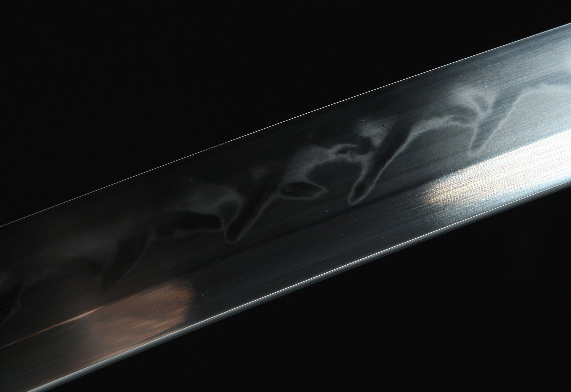 Closeup of the Sakura katana blade, showcasing the beautiful hamon pattern along the polished edge.