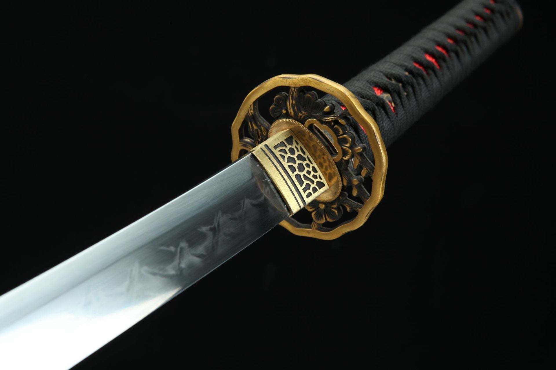 Closeup of the Sakura katana featuring an intricate tsuba with floral design.
