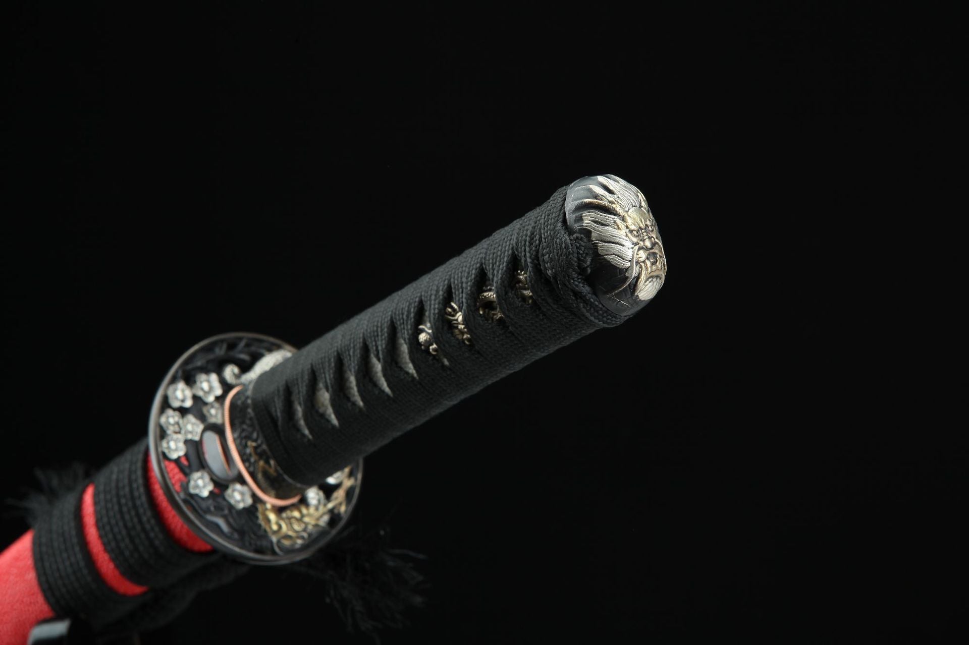 Close-up of sakura ryu katana's pommel (kashira) featuring a detailed ryu head design.